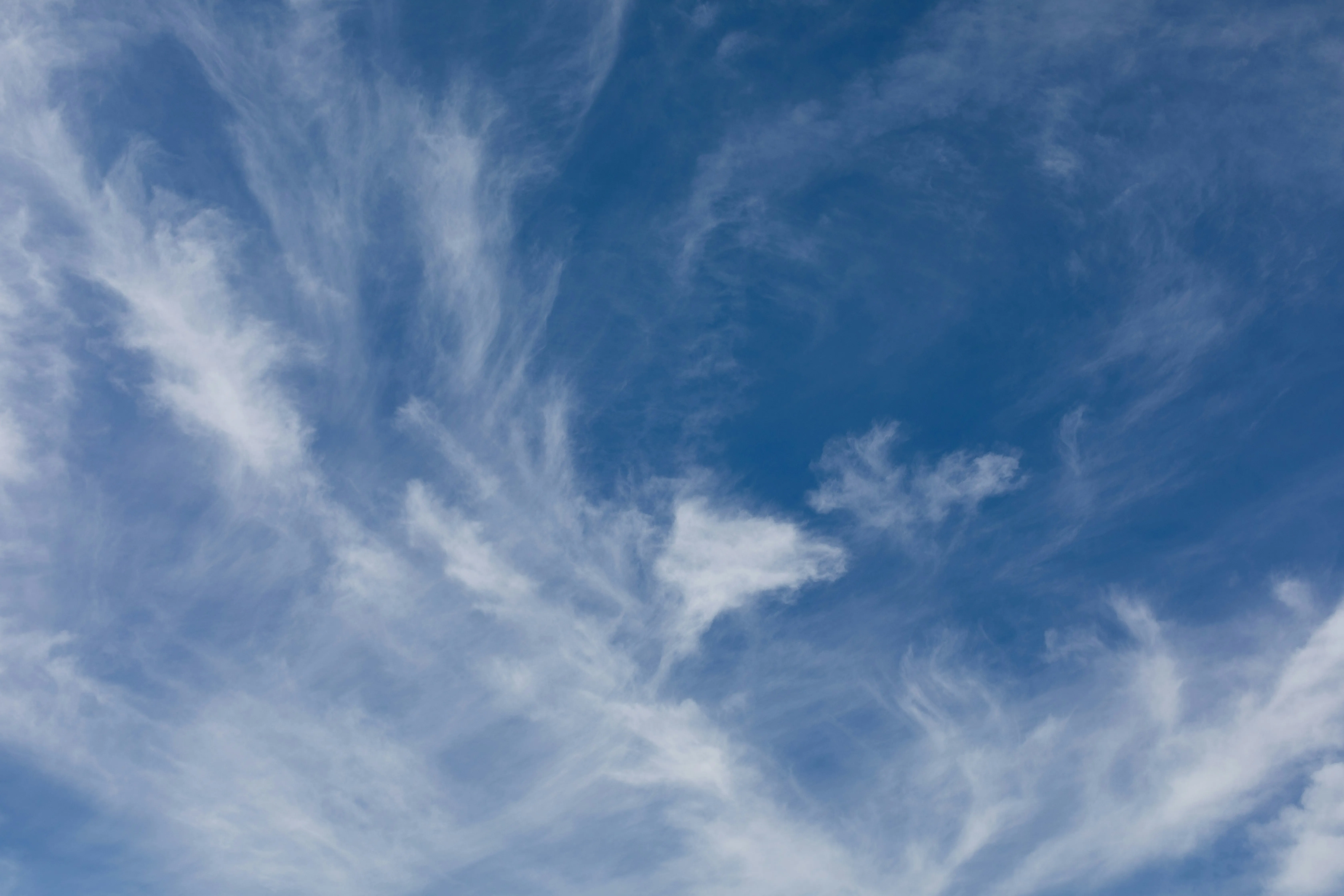 Wispy Cirrus Clouds Spread Across a Bright Blue Sky