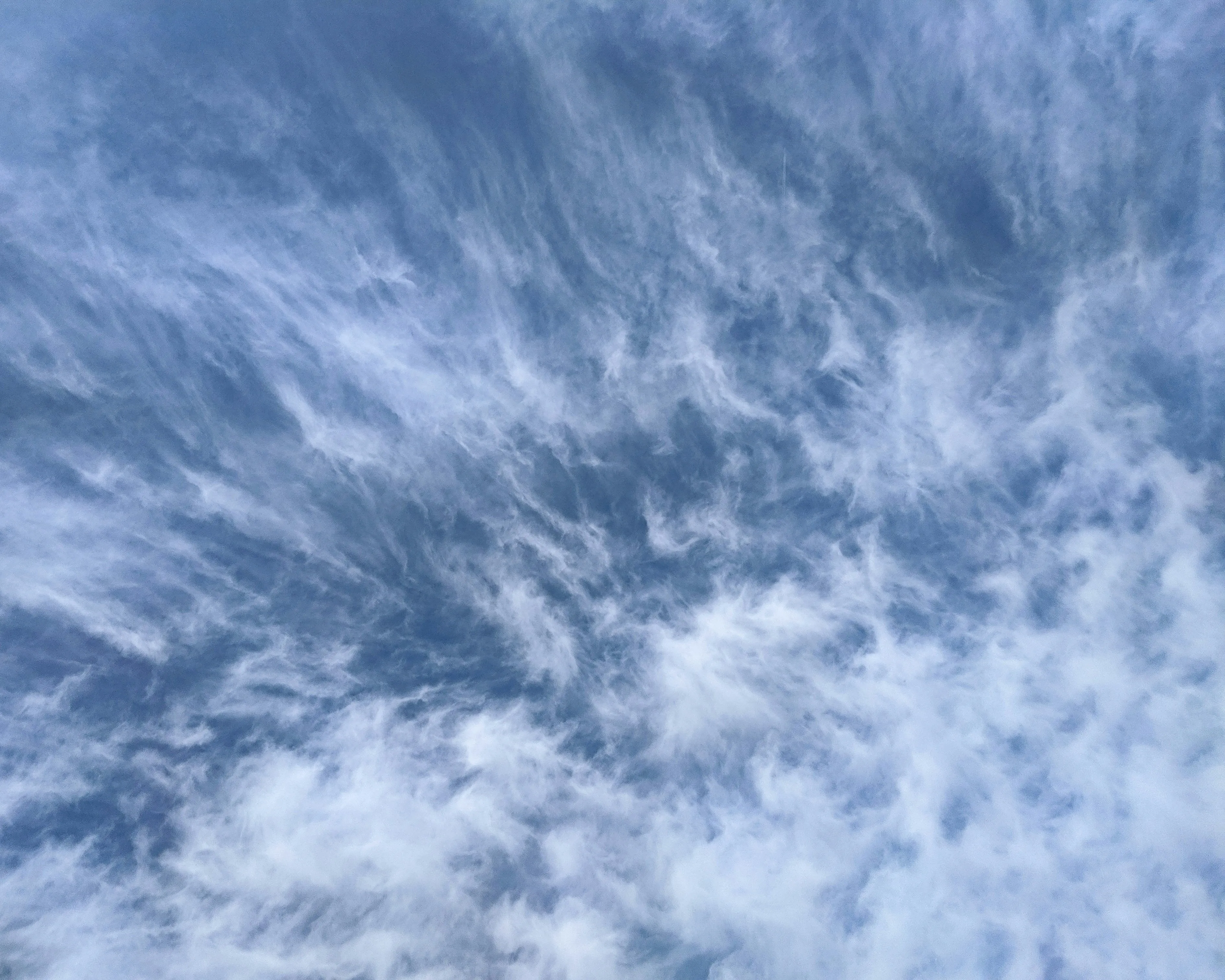 Wispy Cirrus Clouds Stretching Across a Blue Sky Wallpaper