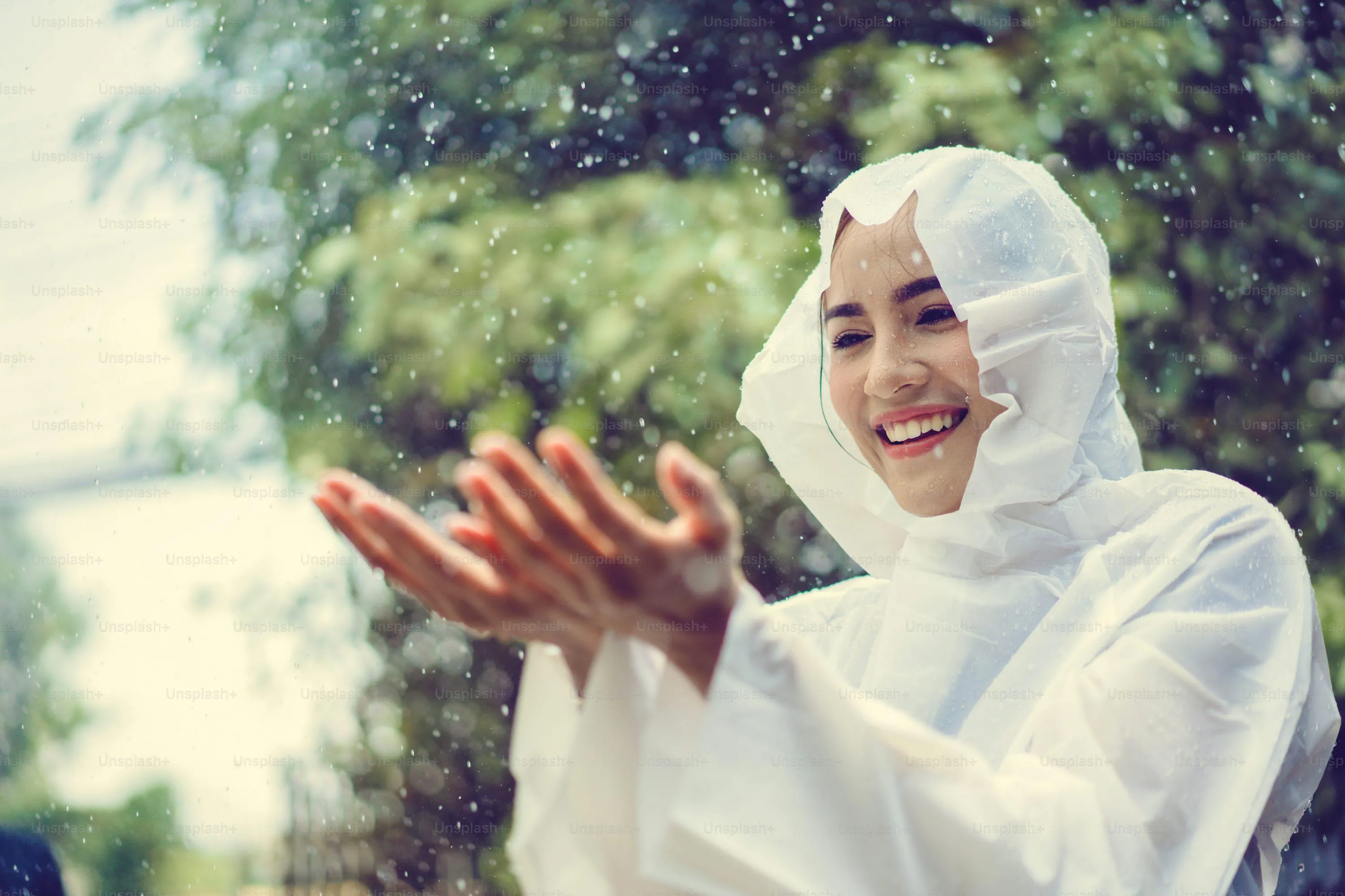 Woman Holding Flowers in Garden with White Raincoat