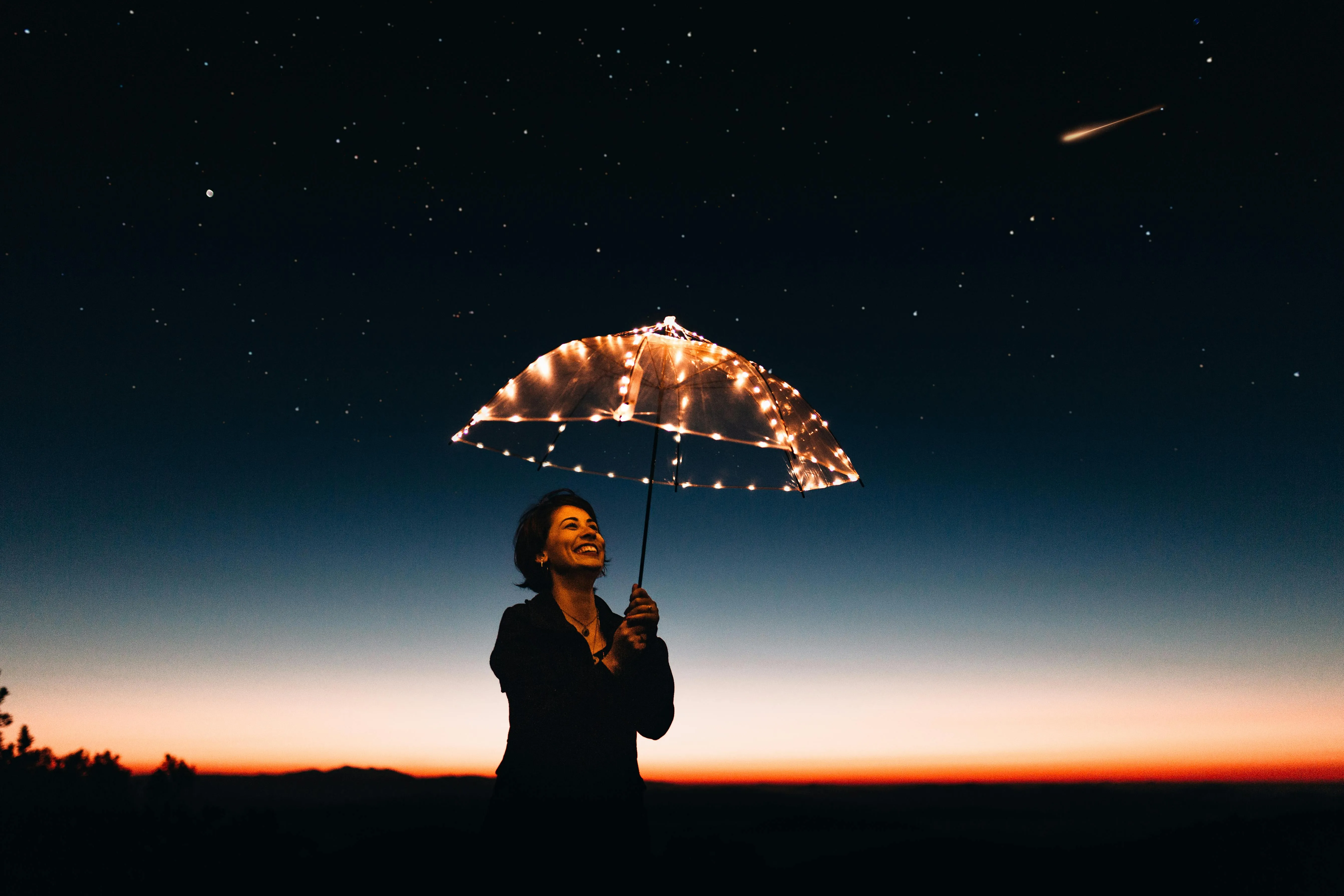 Woman Holding Umbrella Under Starry Night Sky Wallpaper