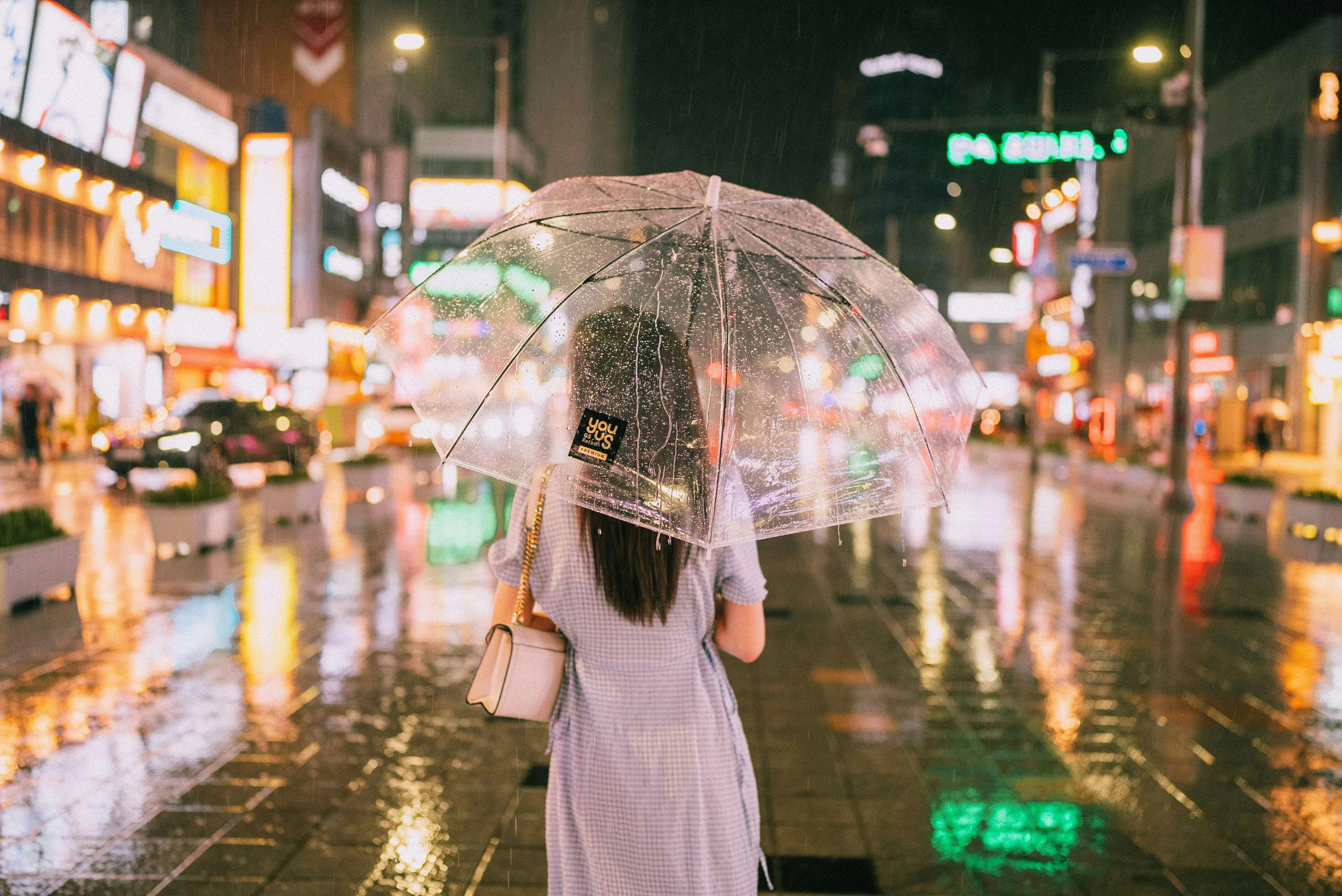 Woman Walking on Bridge in Rain with Umbrella Wallpaper