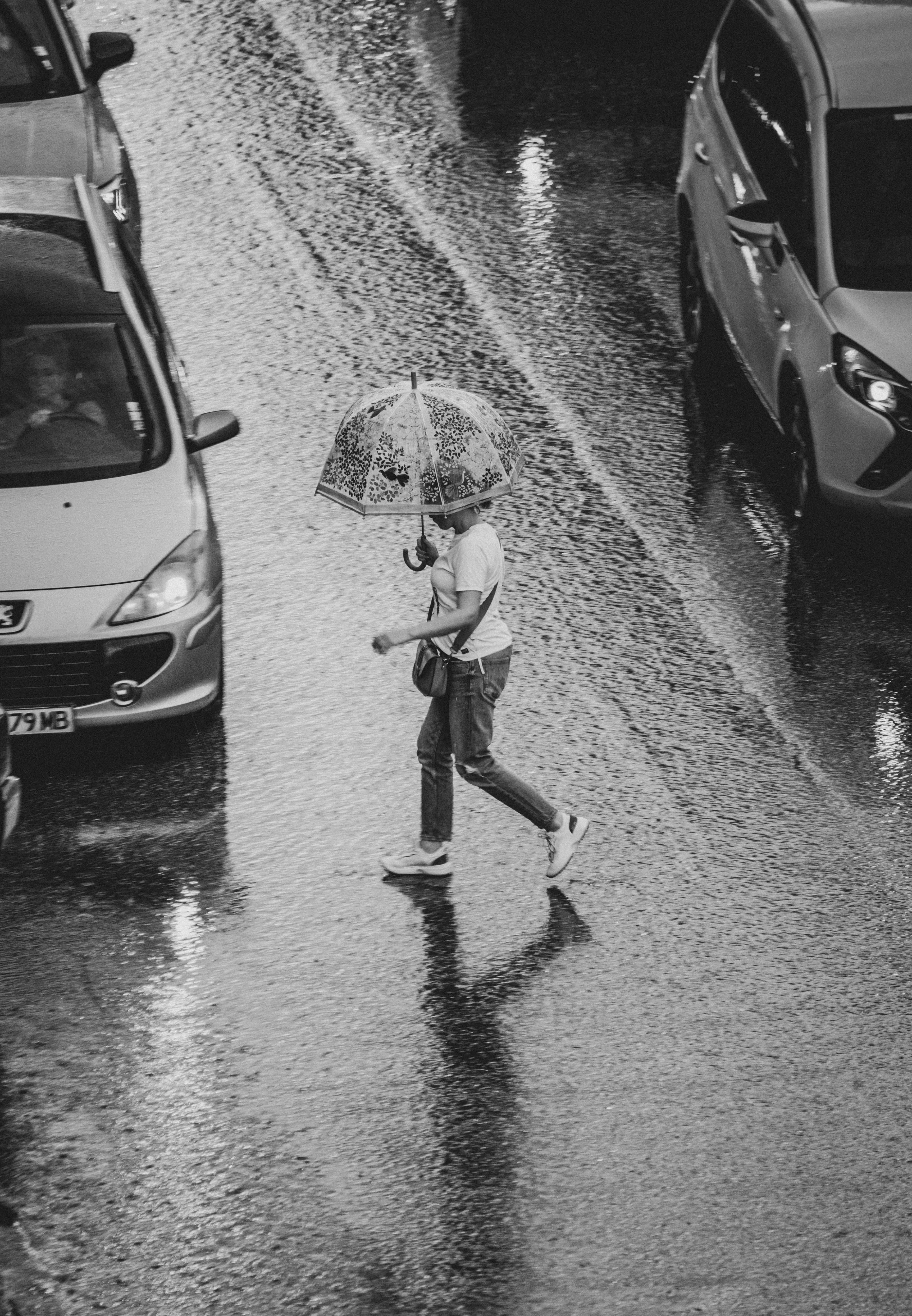 Woman Walking on Street with Umbrella in Rain Image