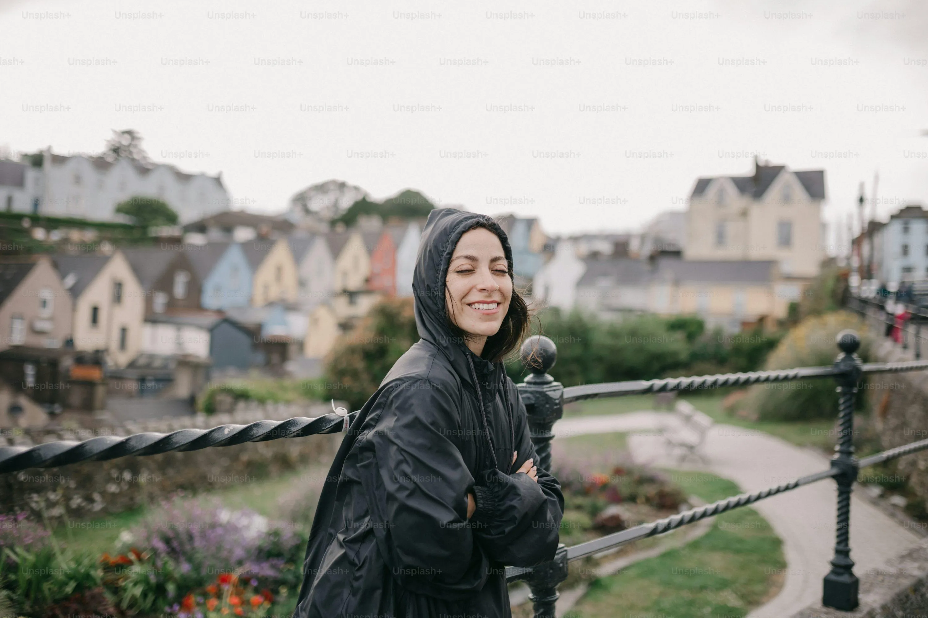 Woman Wearing Black Coat Walking in Rain Near Cityscape