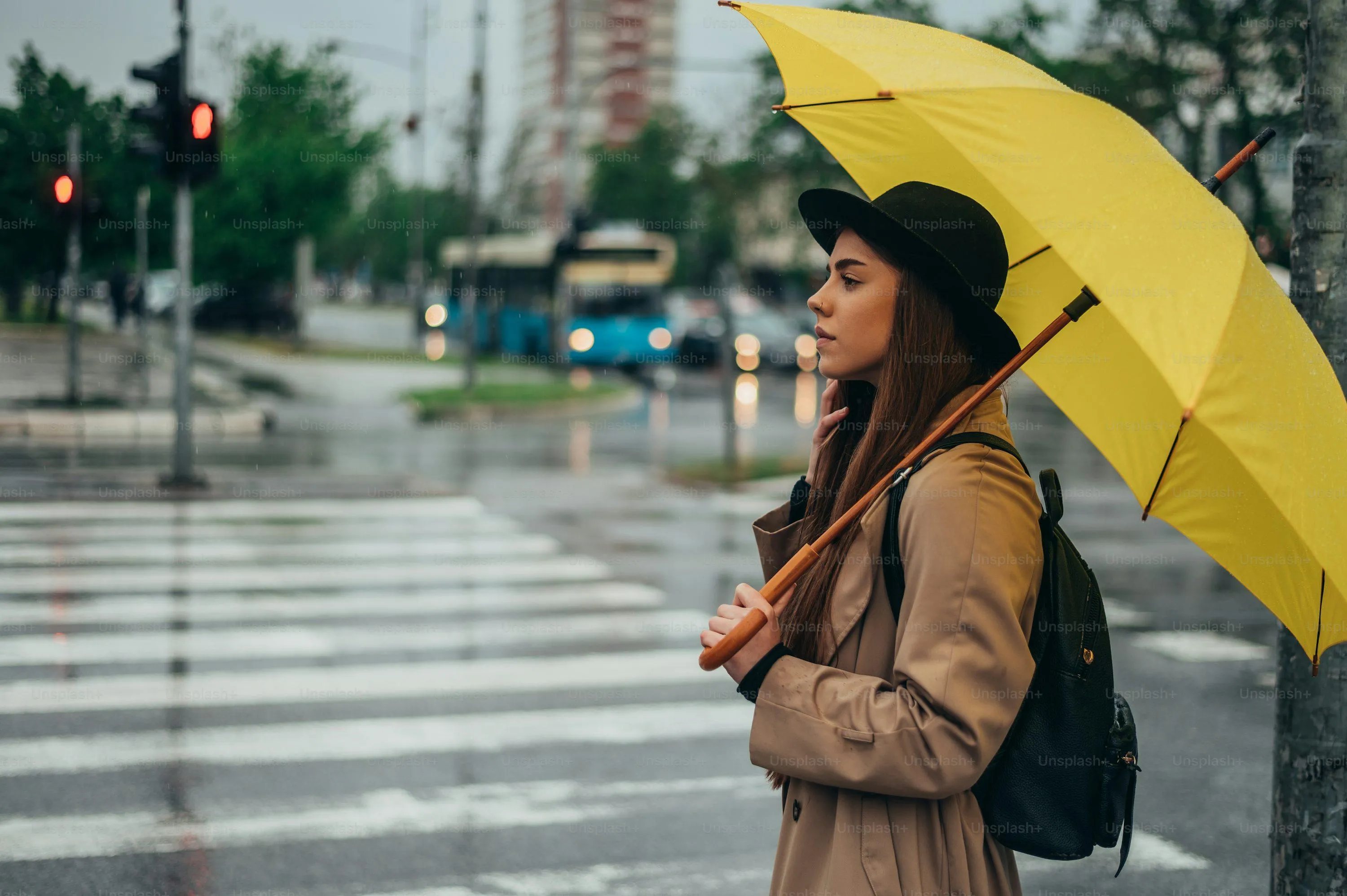 Woman Wearing Yellow Coat Holding Umbrella in Rain