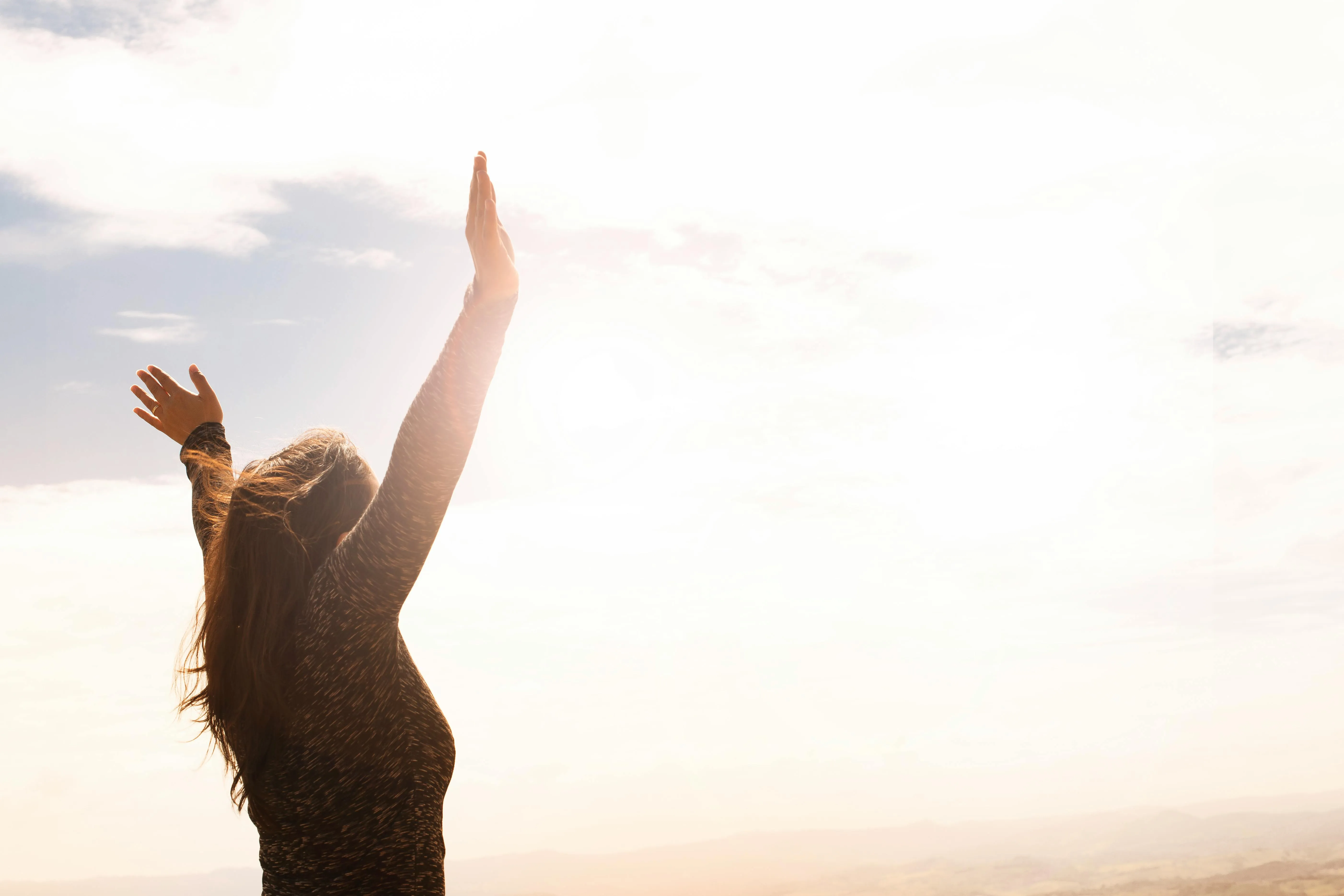 Women Enjoying Sunset with Raised Arms Outdoors Image