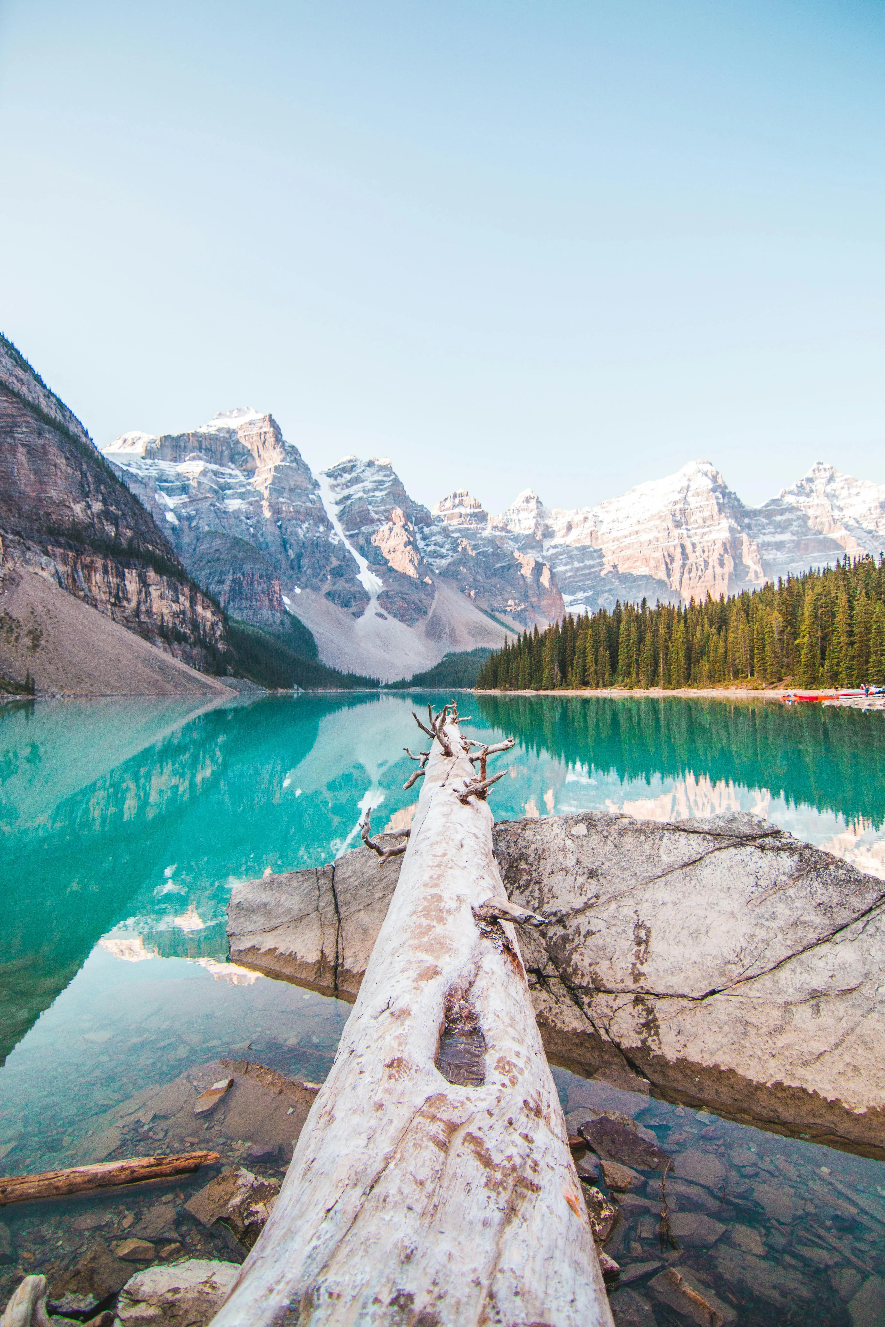 Wooden Pathway Along Turquoise Lake with Mountain Views