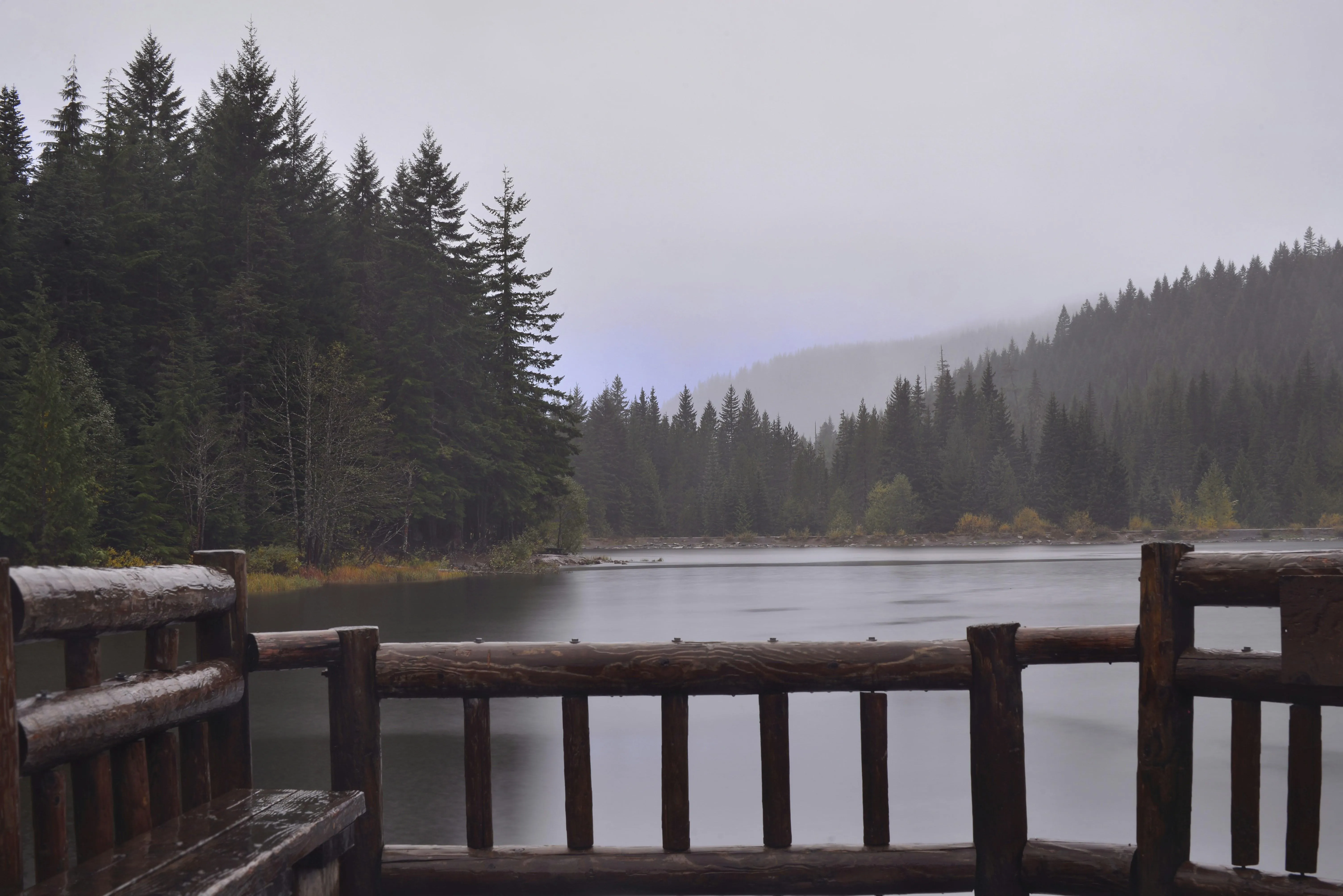 Wooden Pier into Misty Lake Surrounded By Rain Wallpaper