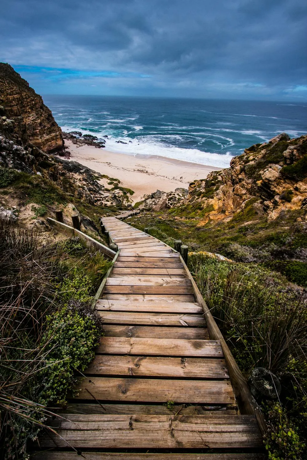 Wooden Walkway Leading Down To a Beautiful Beach Under Clouds