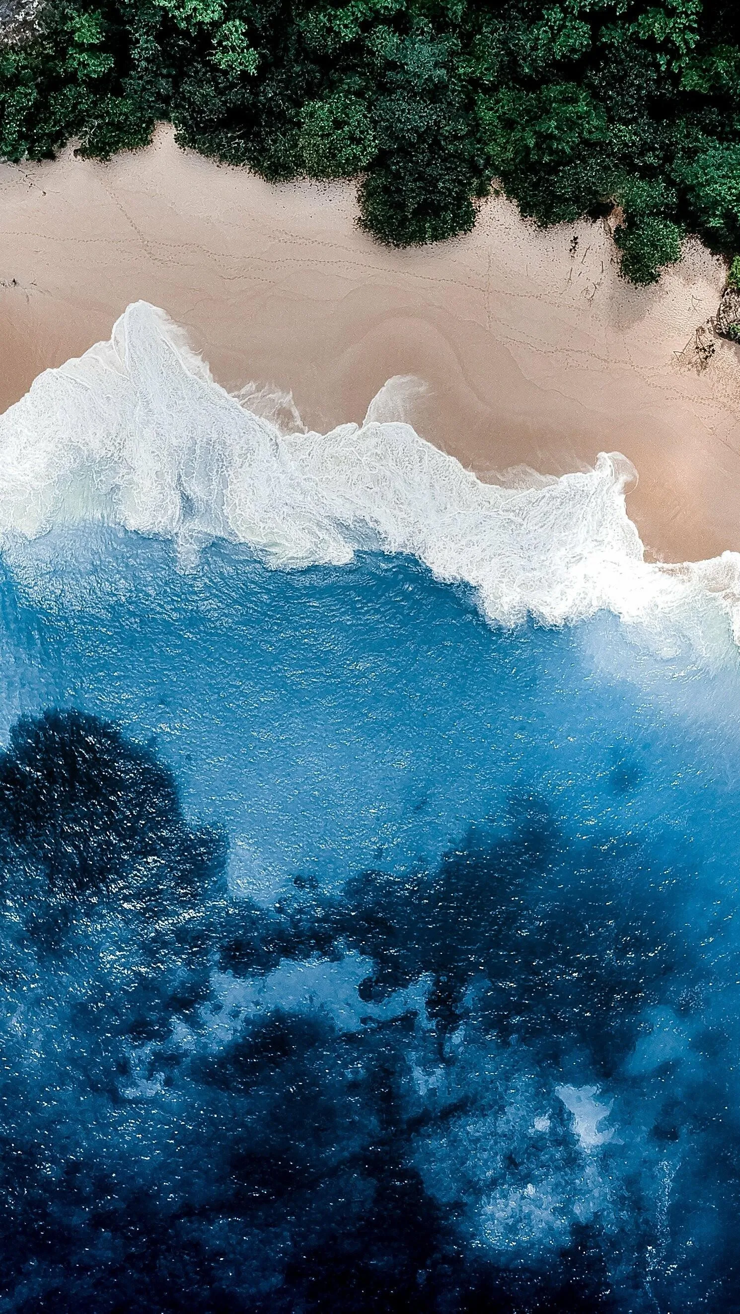 Aerial Beach View with Waves Crashing on White Shoreline