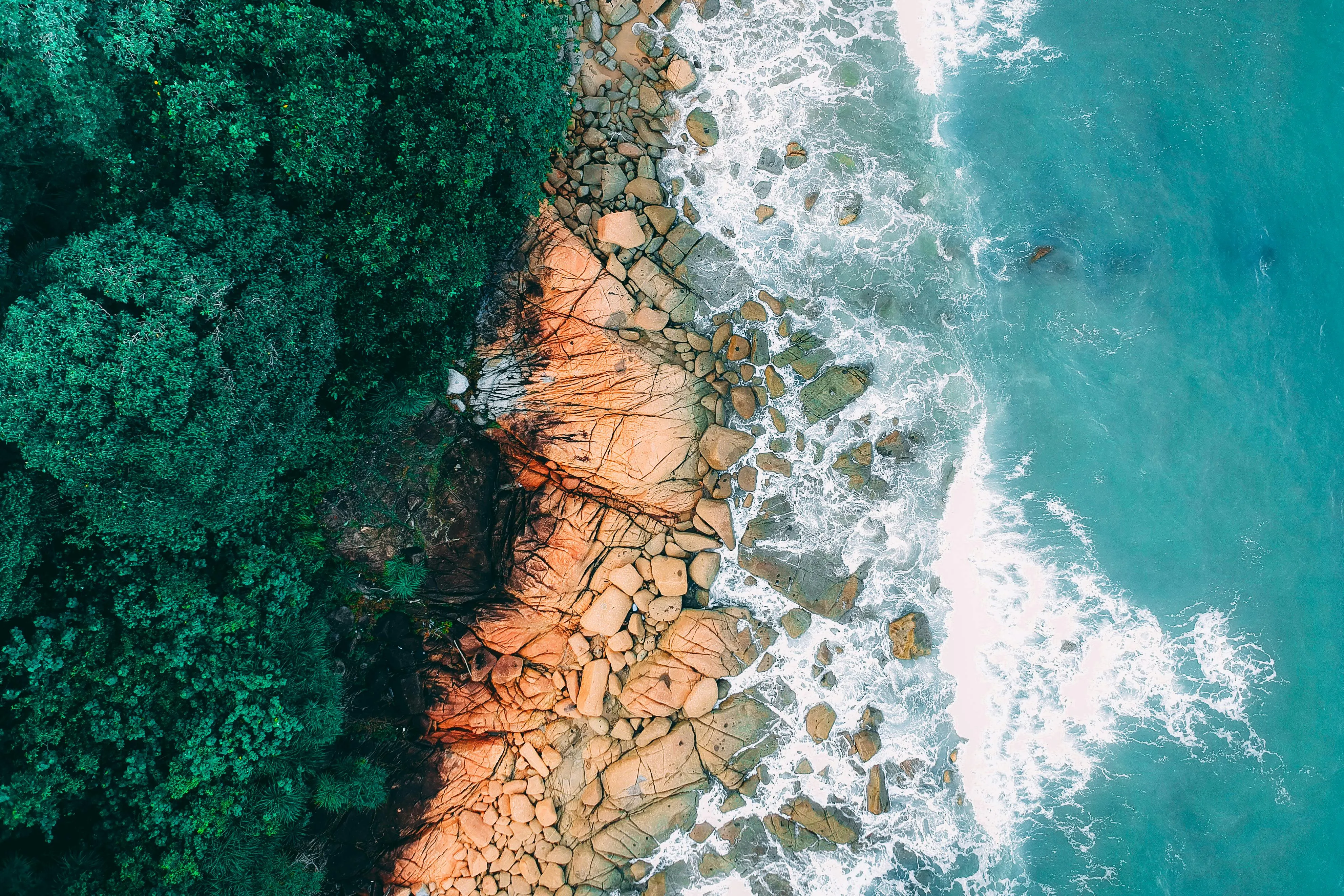 Aerial View of Beach Cliffside and Vibrant Blue Water