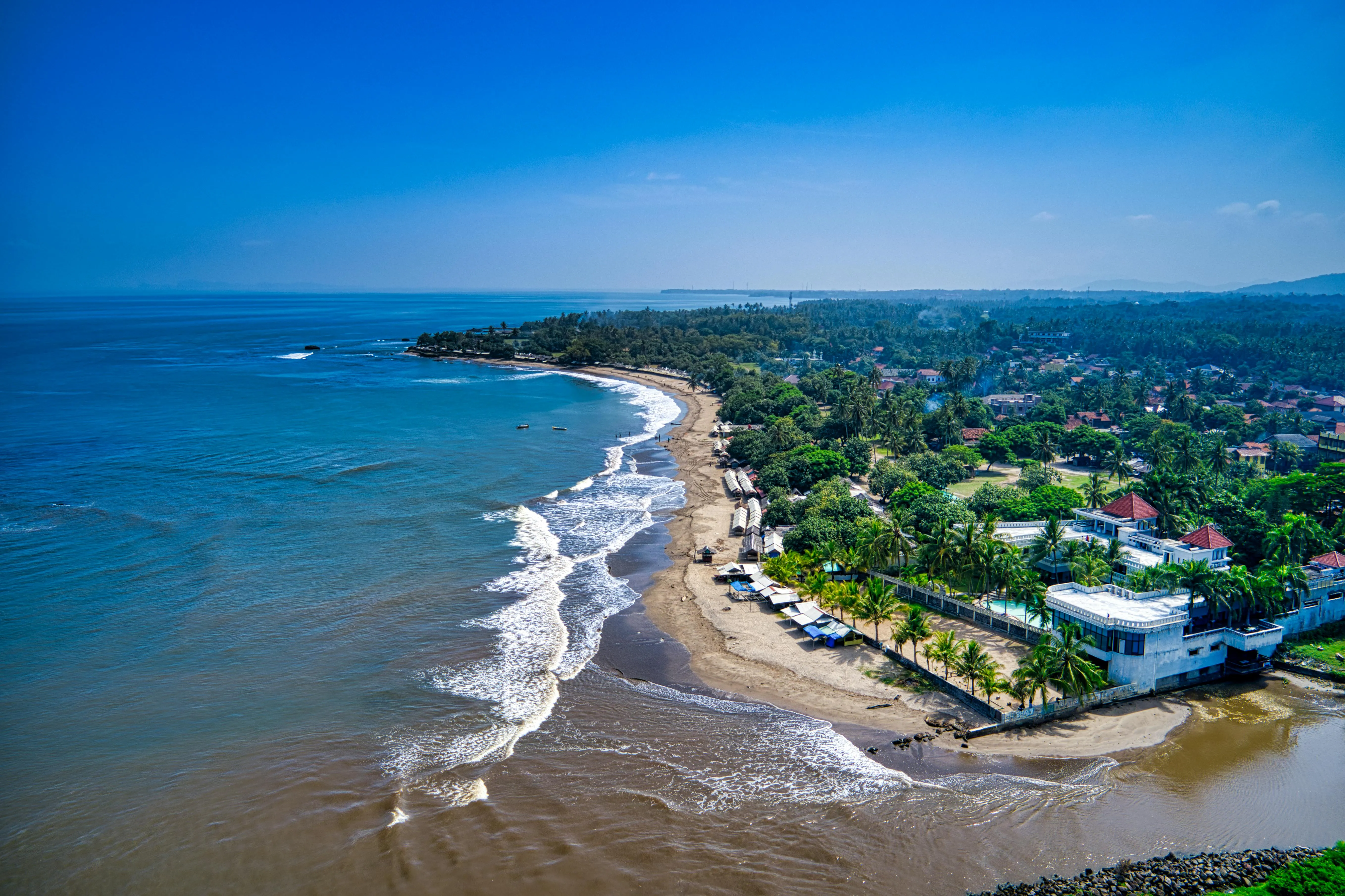 Aerial View of Coastline with a Village with Sea Waves