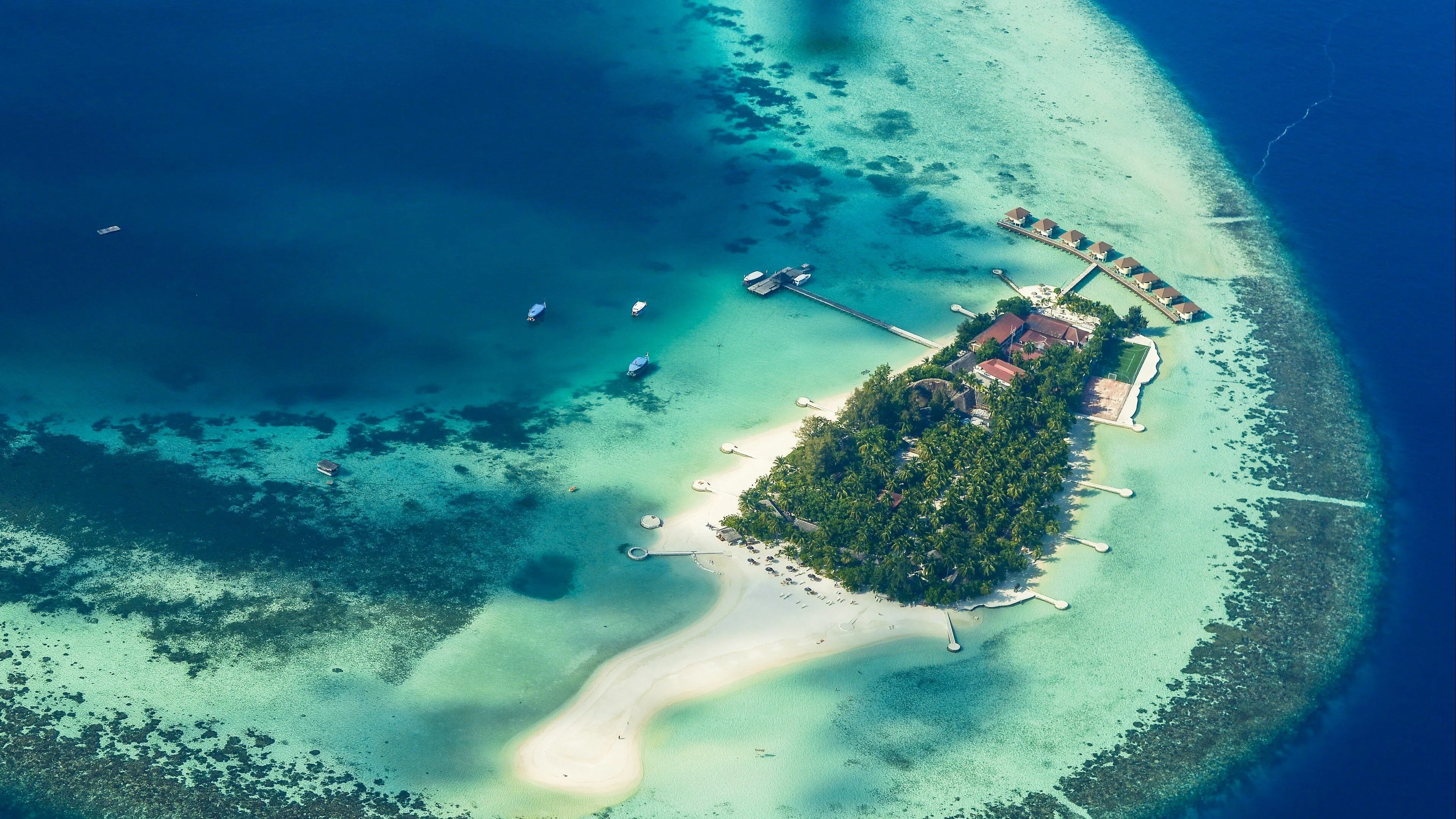 Aerial View of Lush Tropical Island in Crystal Blue Water