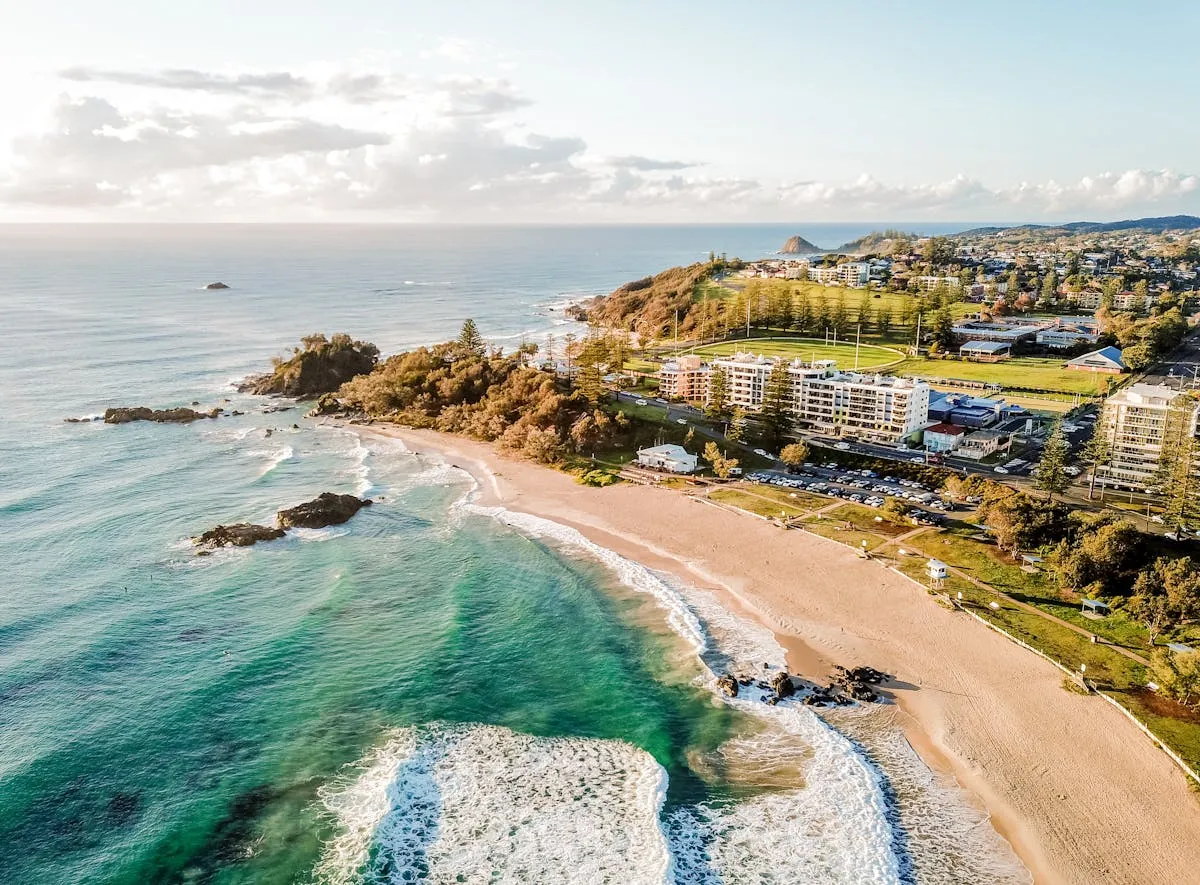 Aerial View of a Sandy Beach Next to a Coastal Town HD Image