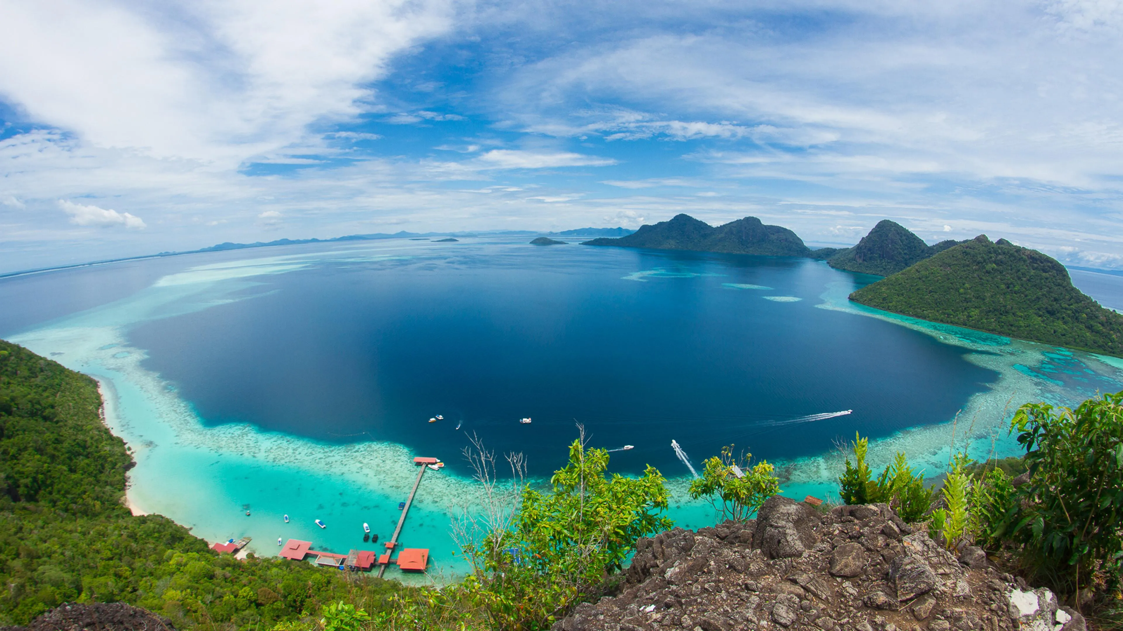 Aerial View of a Tropical Island Surrounded by Turquoise Sea
