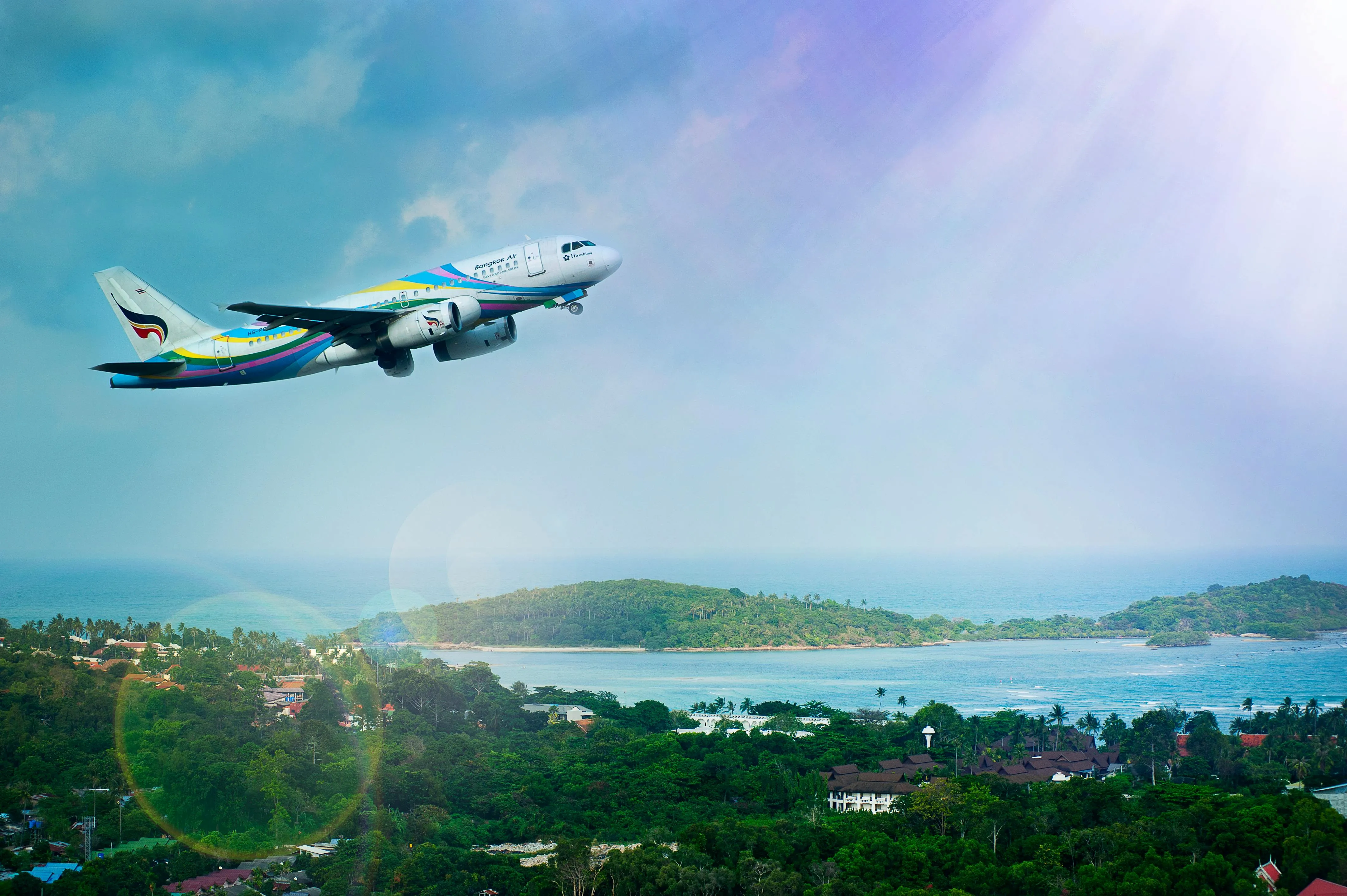 Airplane Flying Above a Tropical Island with an Ocean View