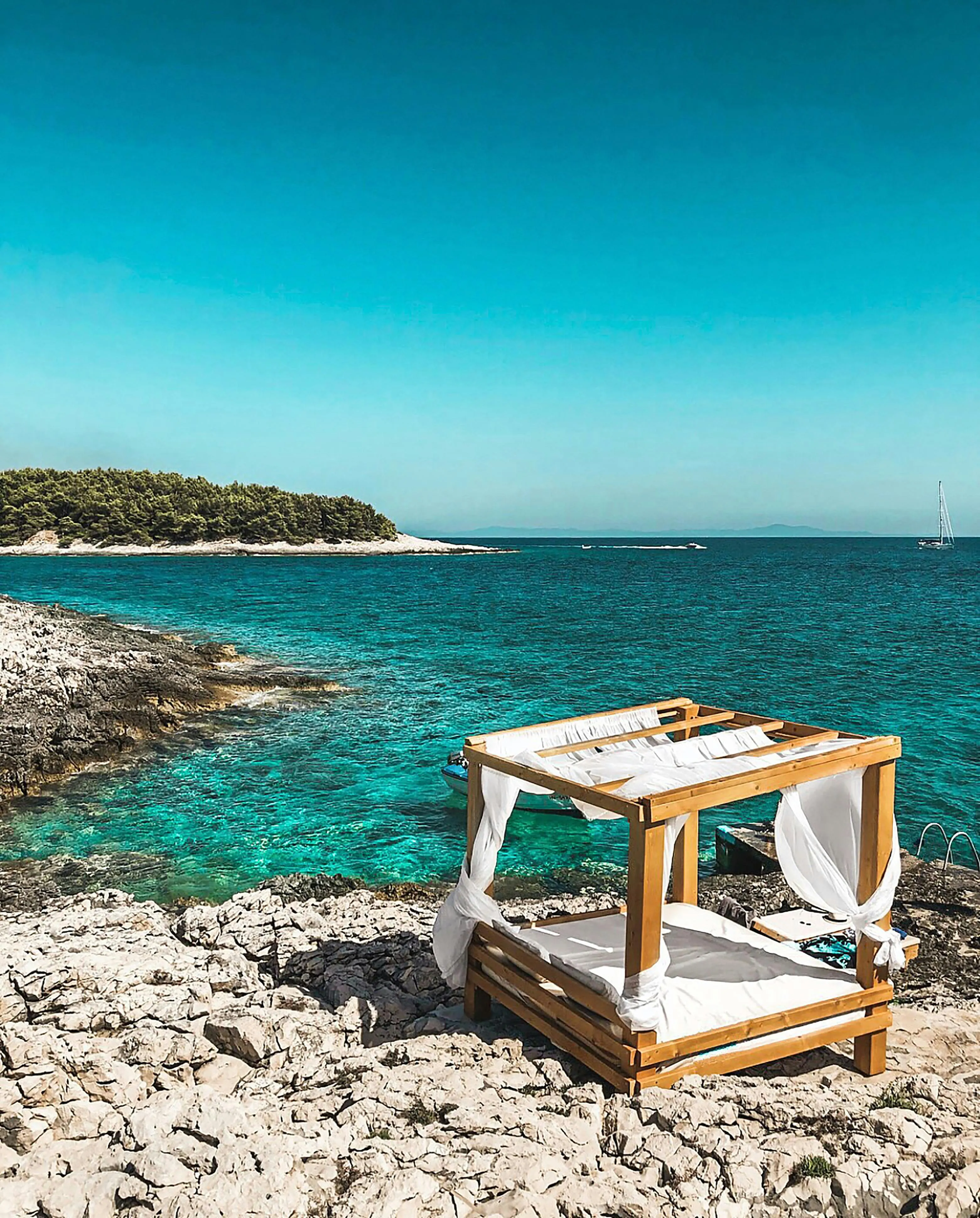Beach Bed Setup on Shore with Ocean Waves and Sky Wallpaper