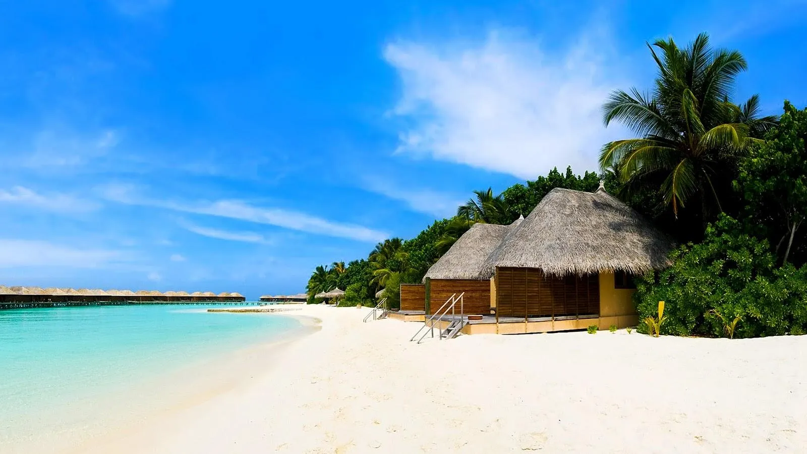 Beachfront Bungalows on White Sand and Blue Sea Wallpaper