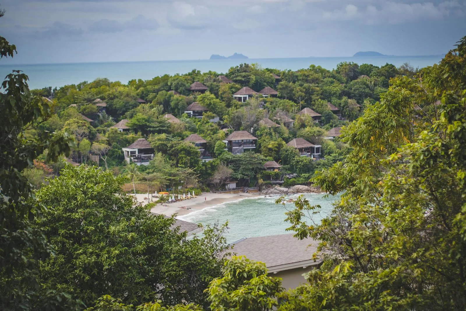 Beachside Village Surrounded by Trees and Hills Wallpaper