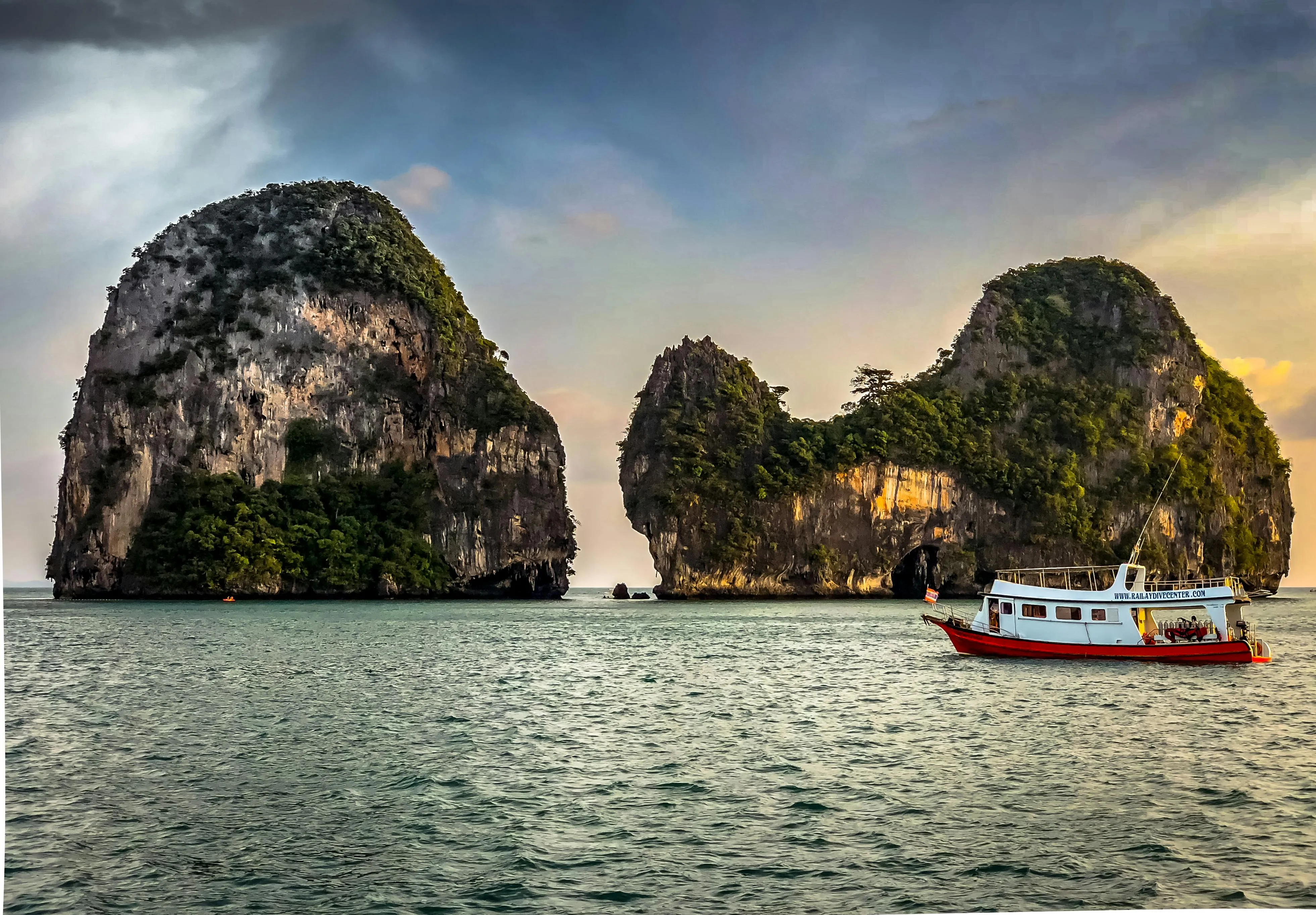 Beautiful Rocky Islands with a Boat Floating on Calm Water