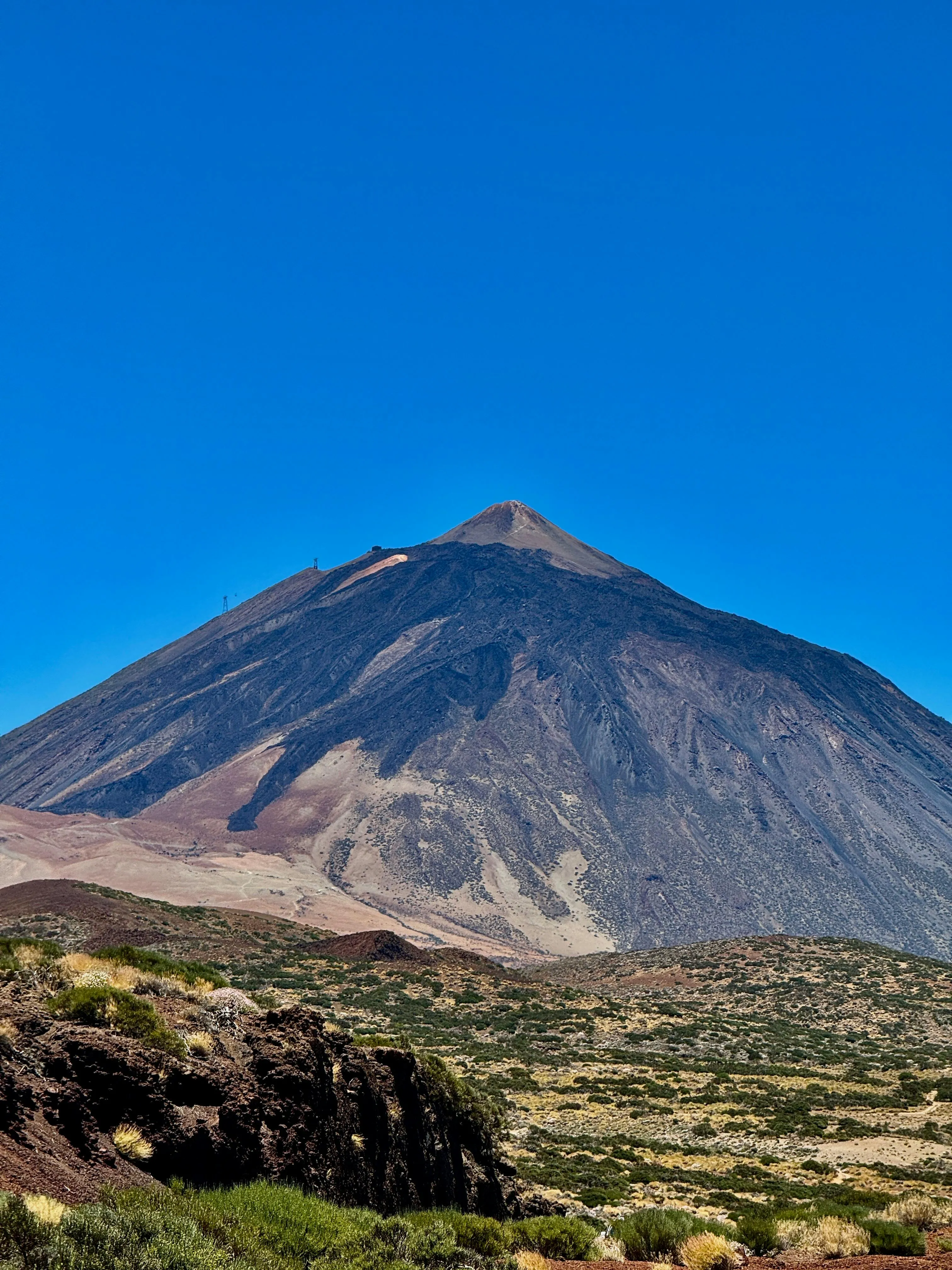 Black Mountain with Rocky Terrain Under a Bright Sky