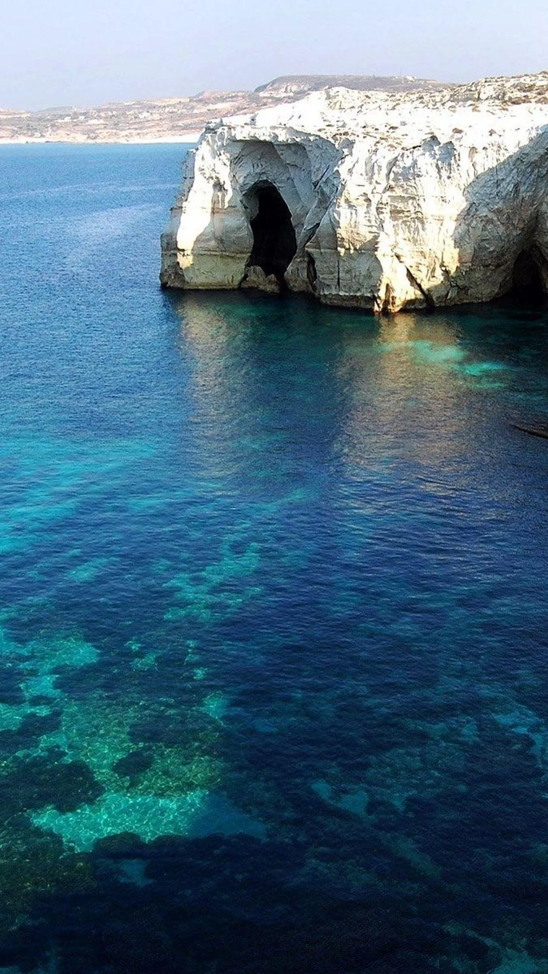Blue Ocean with Stone Cliffs and Clear Shallow Reef Waters