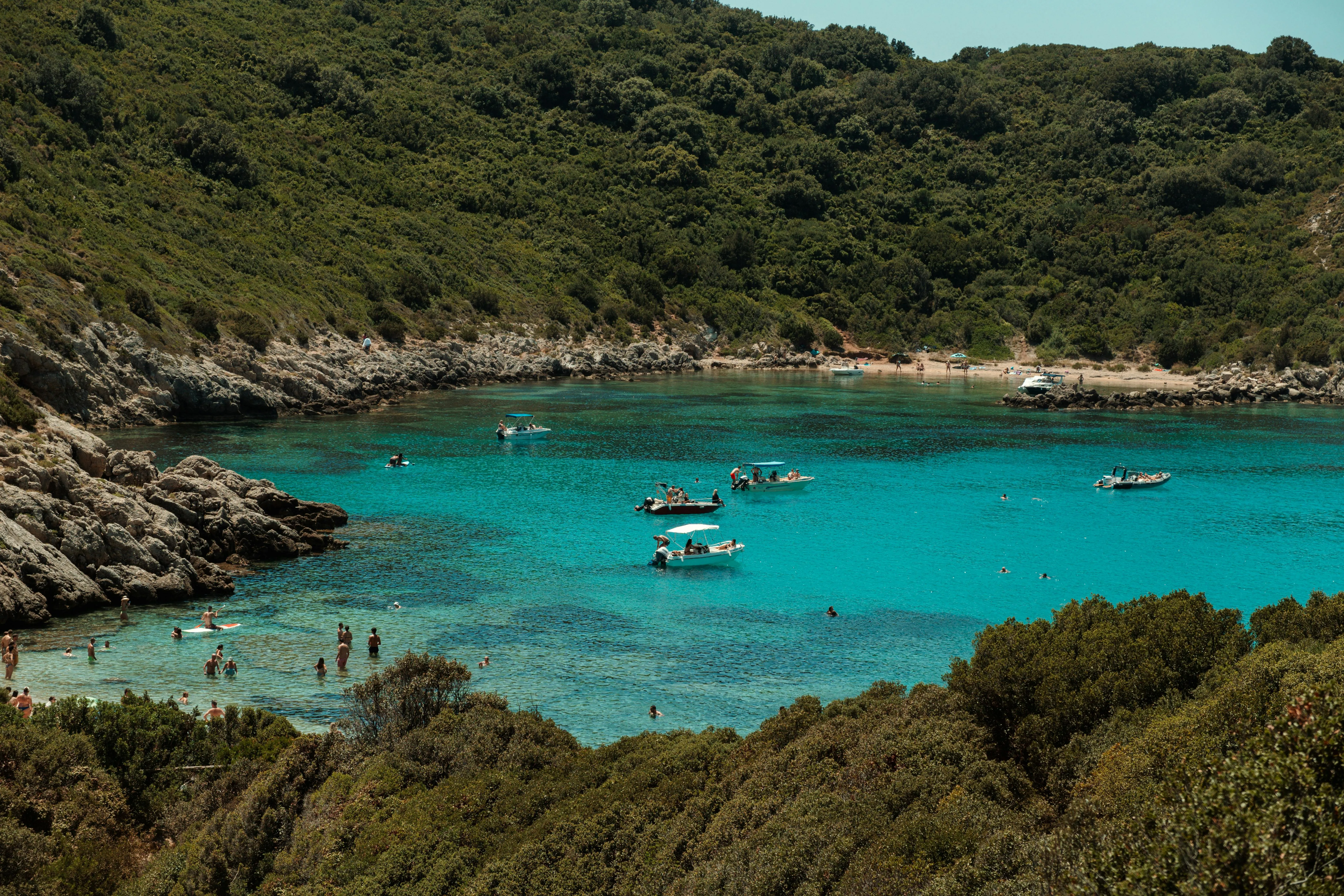 Boats Floating in a Quiet Cove with Rocky Green Hills
