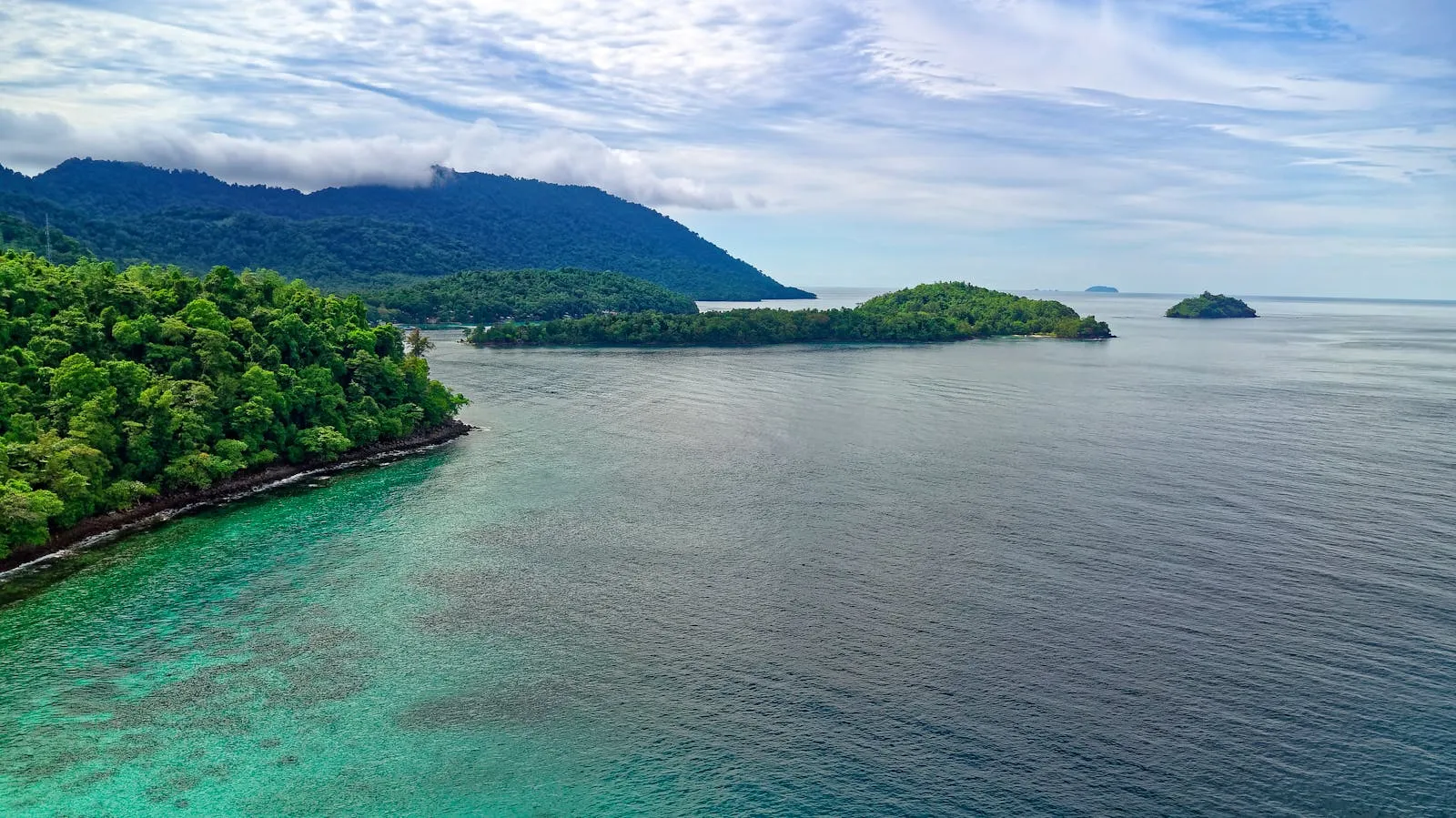 Calm Ocean Waters with a Forested Island in the Distance