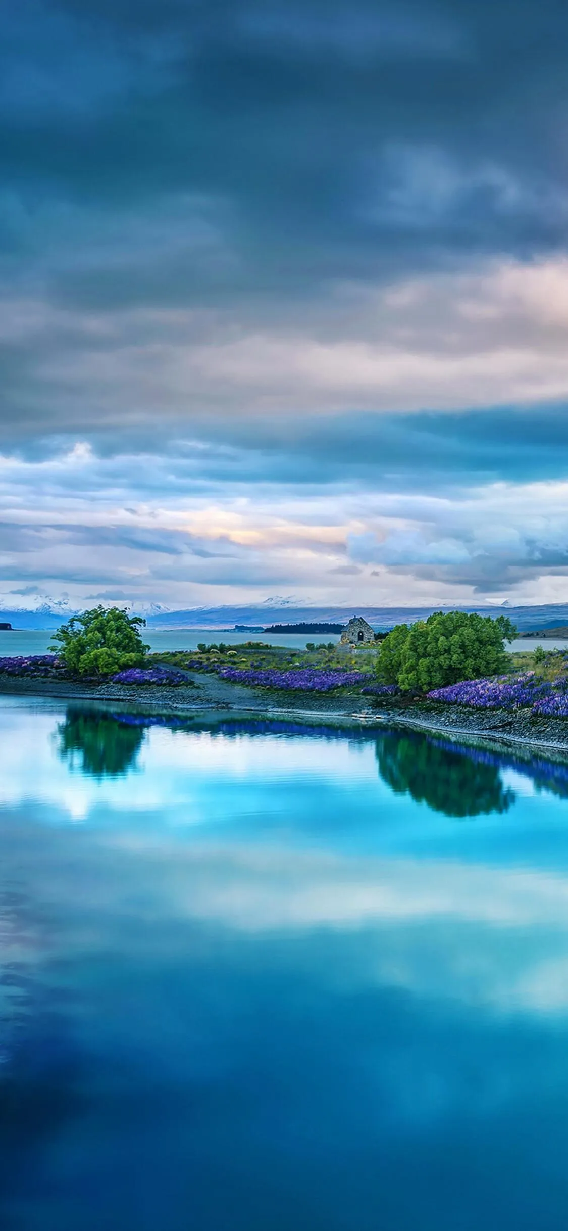 Calm Reflective Water Under a Moody Cloudy Sky Landscape