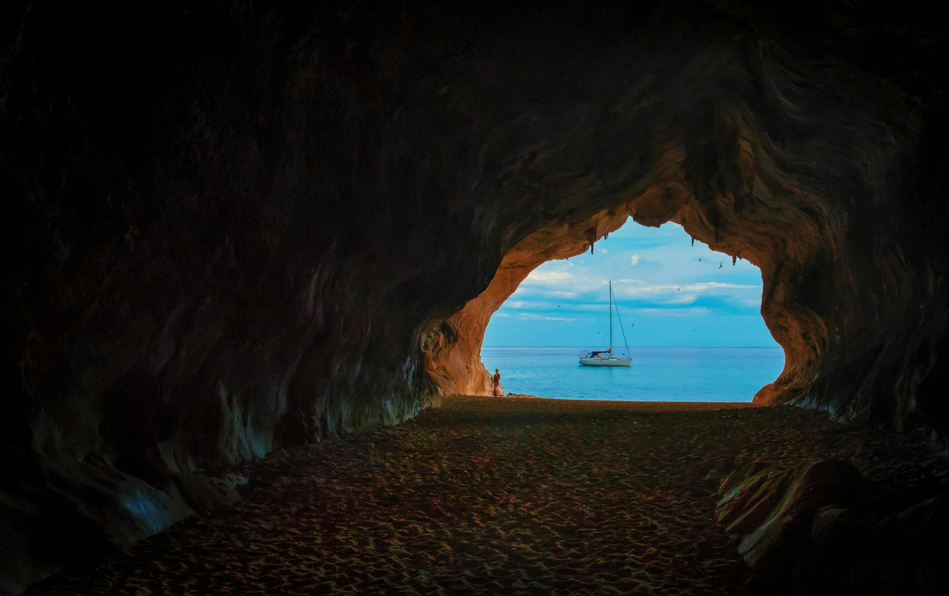Cave Opening Framing of a Ship and a Glowing Blue Seascape