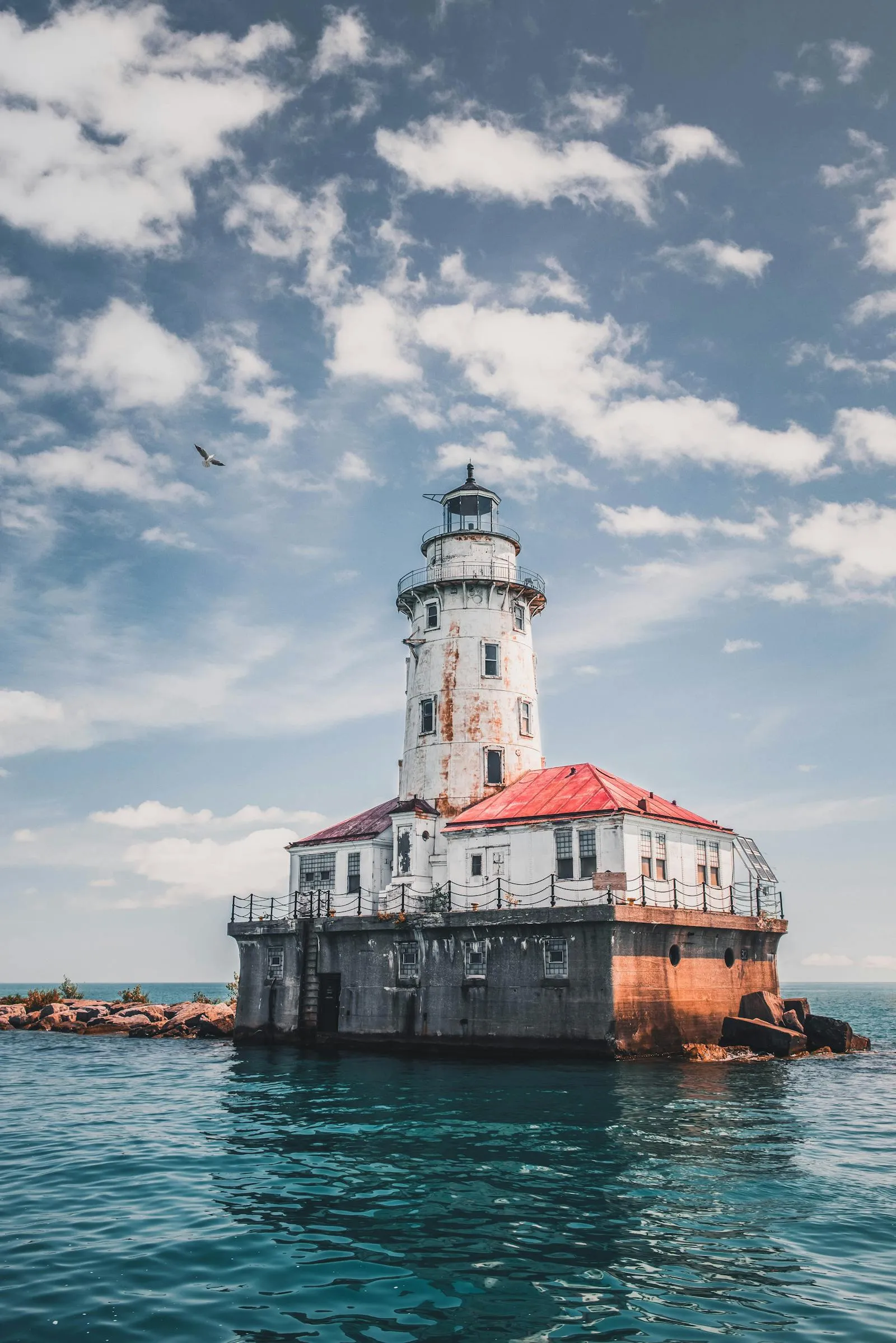 Classic Lighthouse Standing over Peaceful Ocean Water