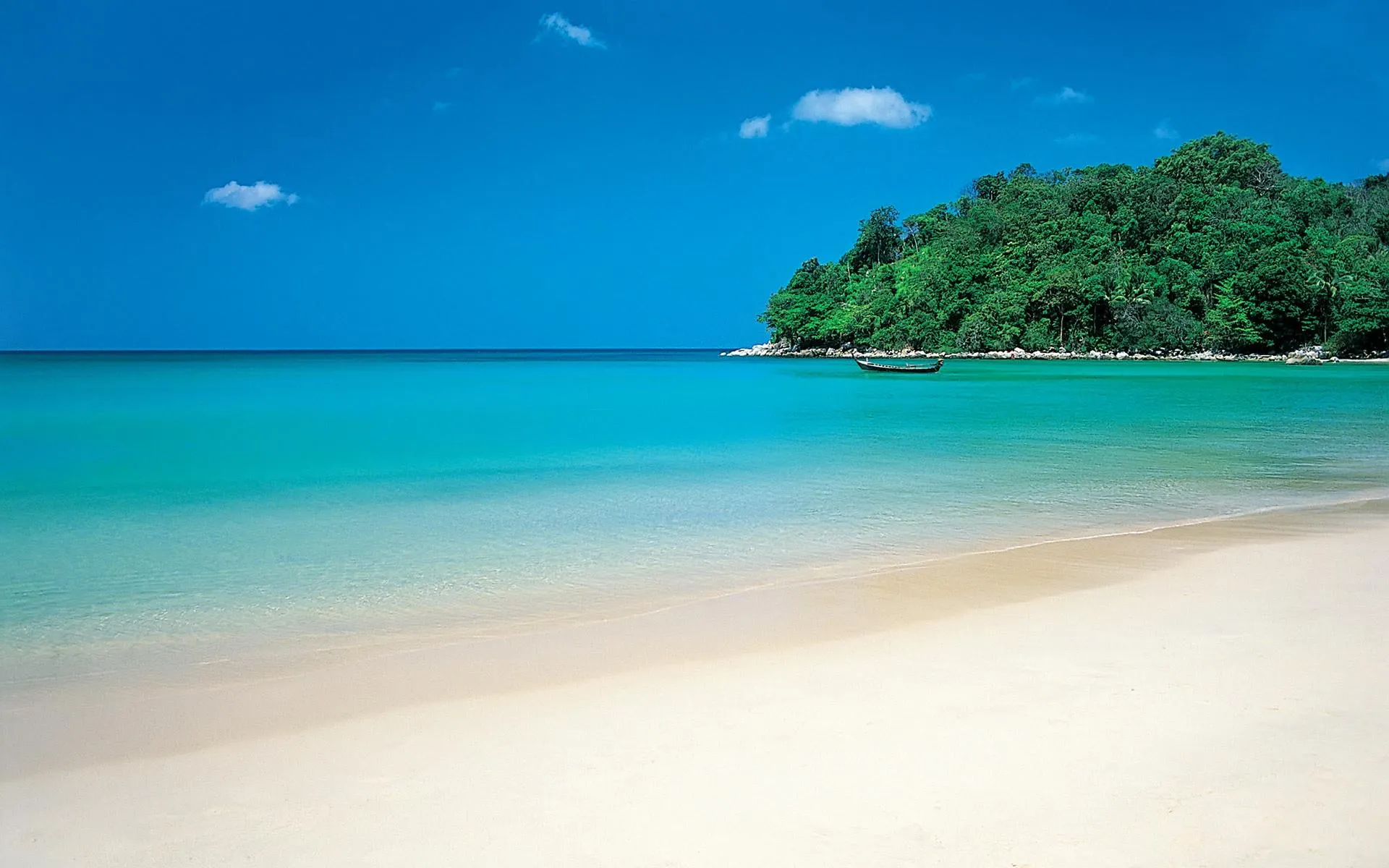 Clear Turquoise Water Meets Soft Sand on a Quiet Beach Day