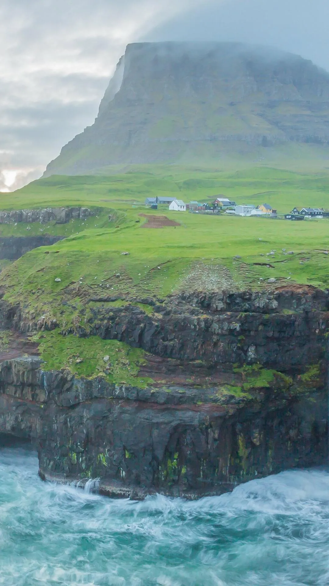 Cliffside Island with a Grassy Top Above the Ocean Waves