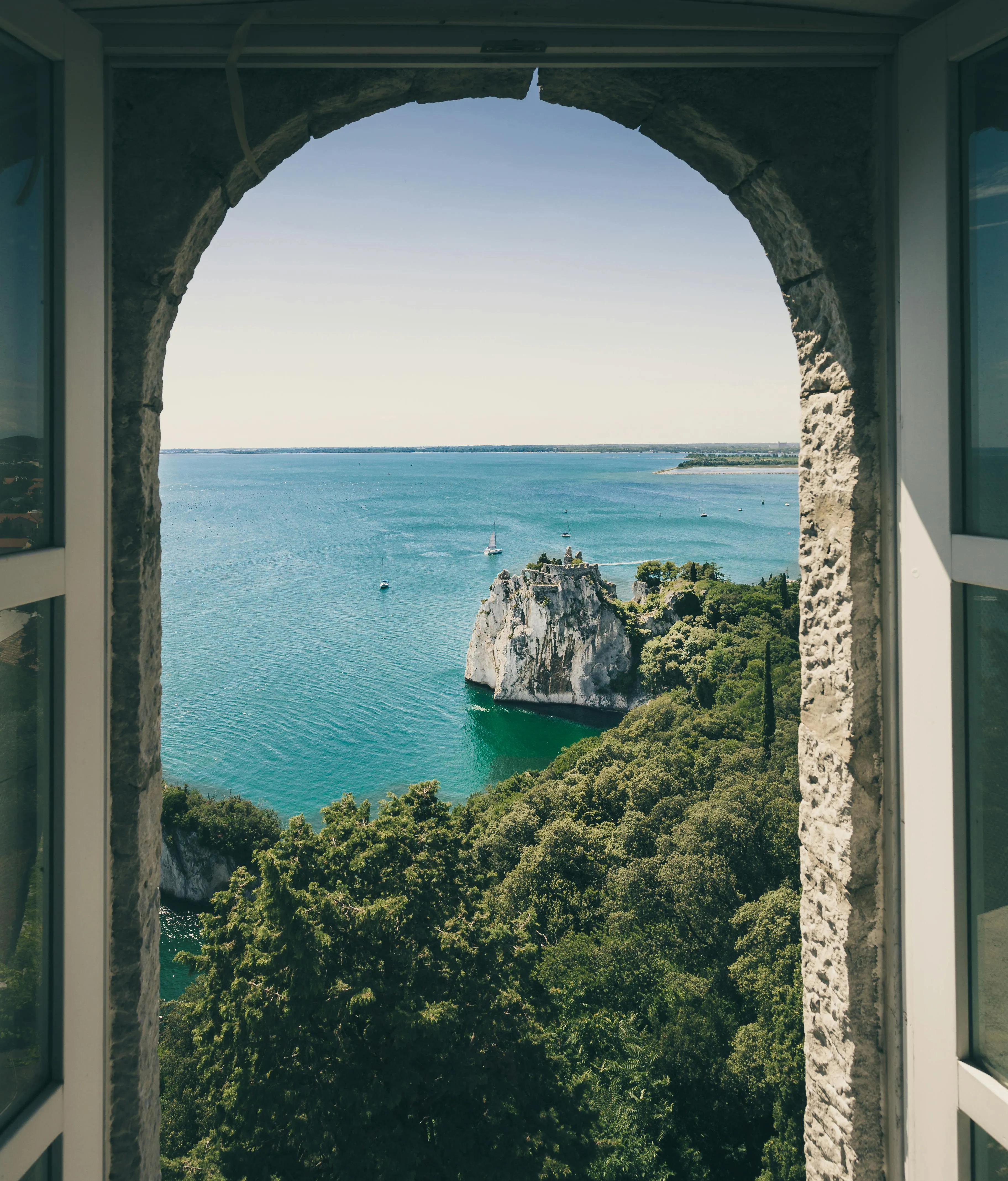 Coastal Island Seen Through an Arched Stone Balcony Window