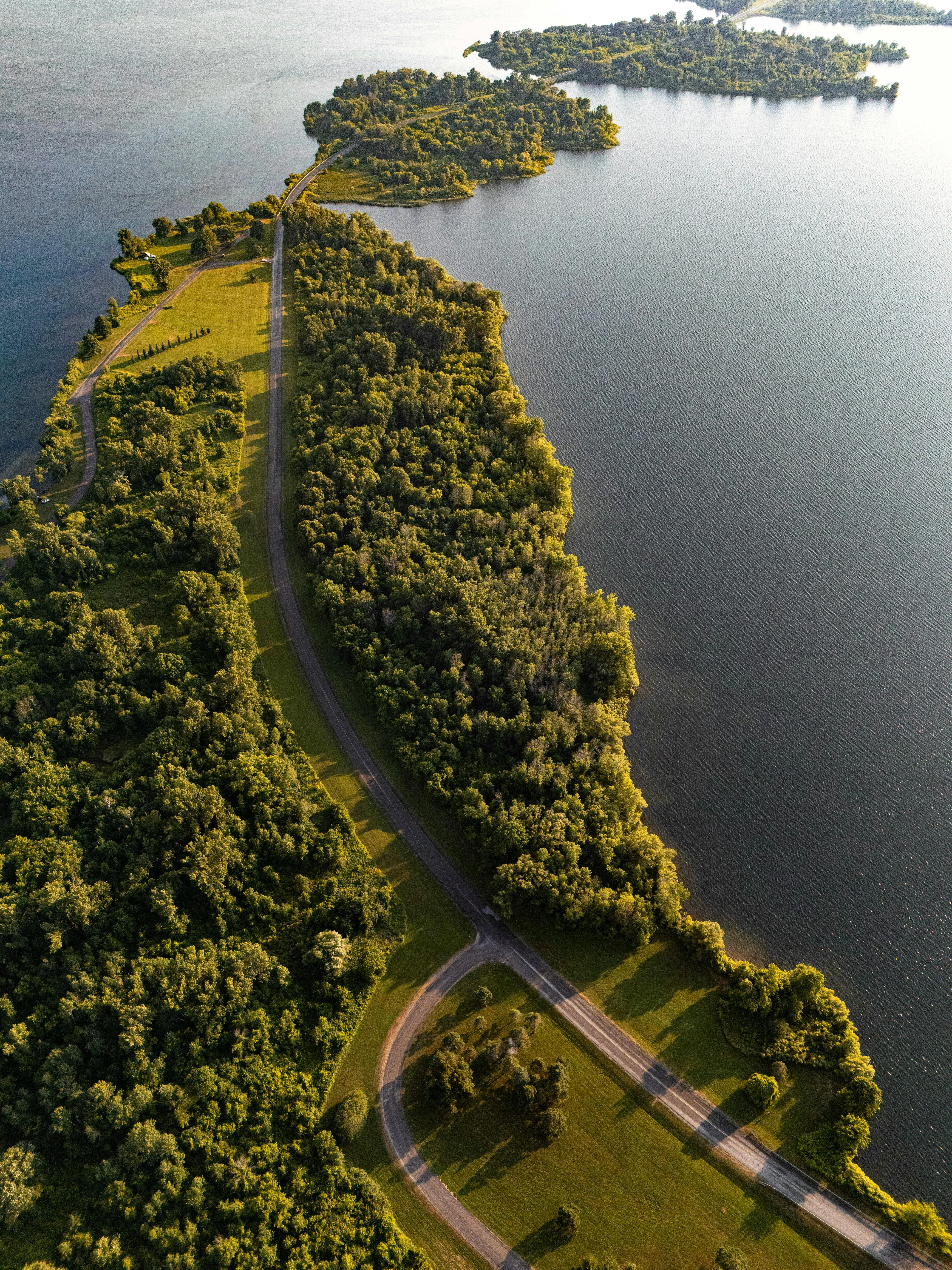 Coastal Road Beside Green Cliffs and Deep Blue Water