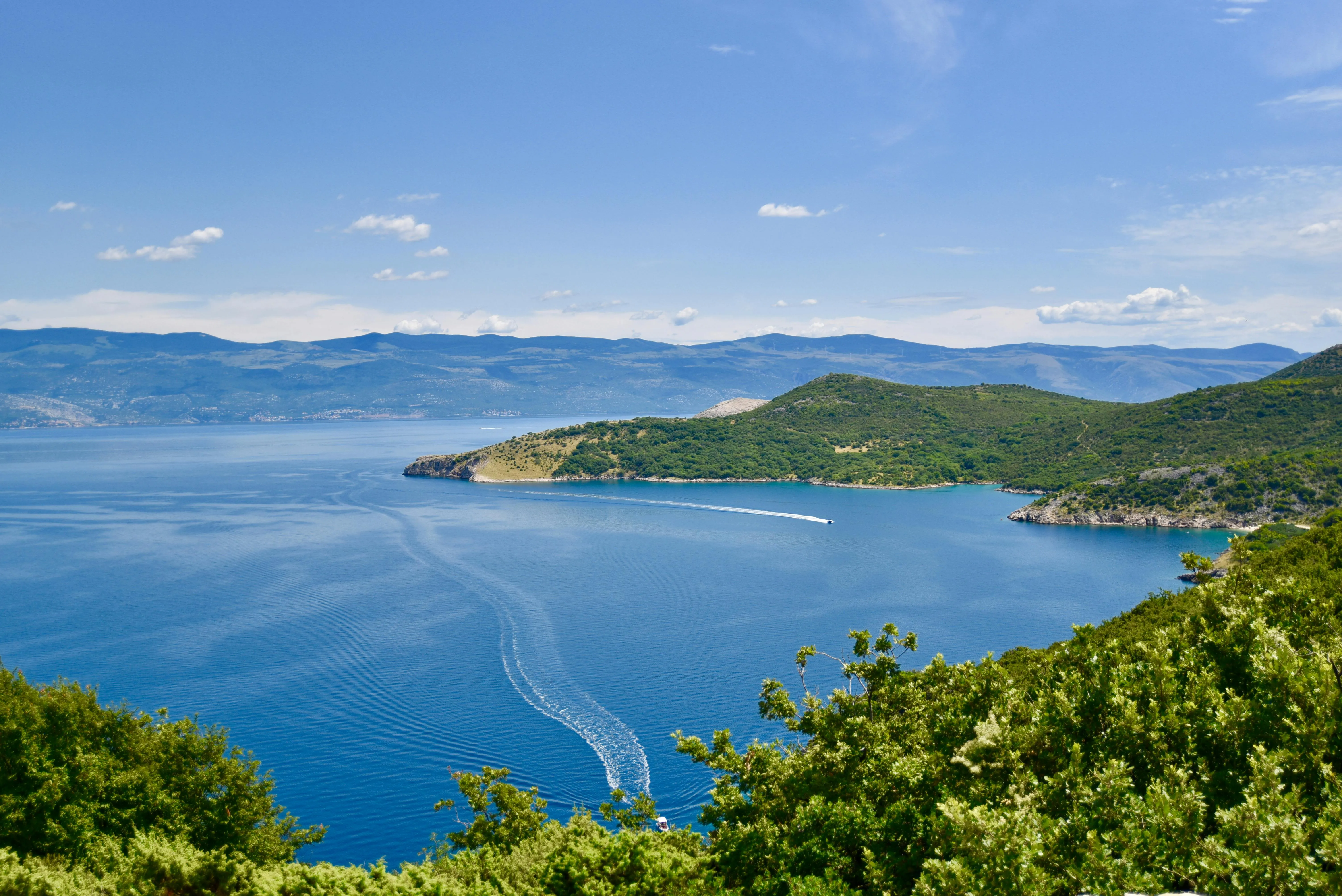 Coastal View of the Blue Sea and Green Hills on a Sunny Day