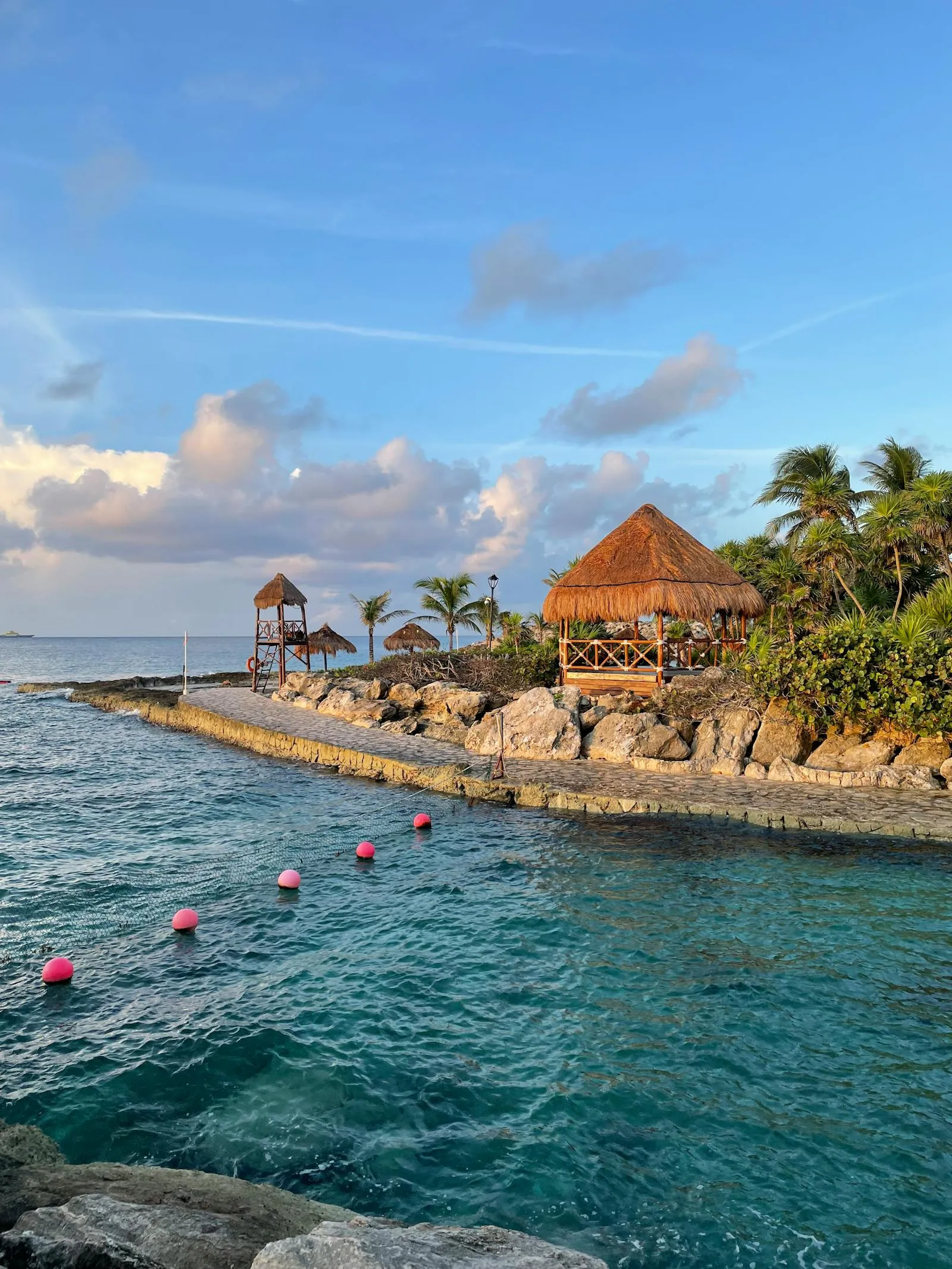 Coastal Village with Boats and Palm Trees at Sunset