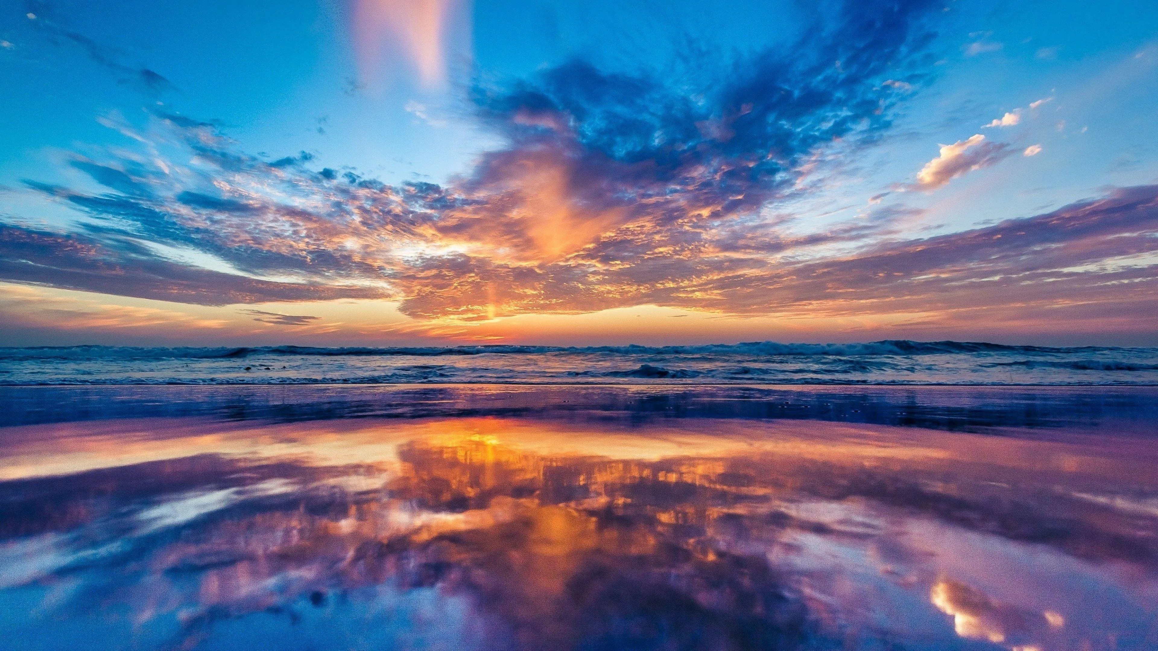 Colorful Evening Sky Reflecting over Ocean Surface Wallpaper
