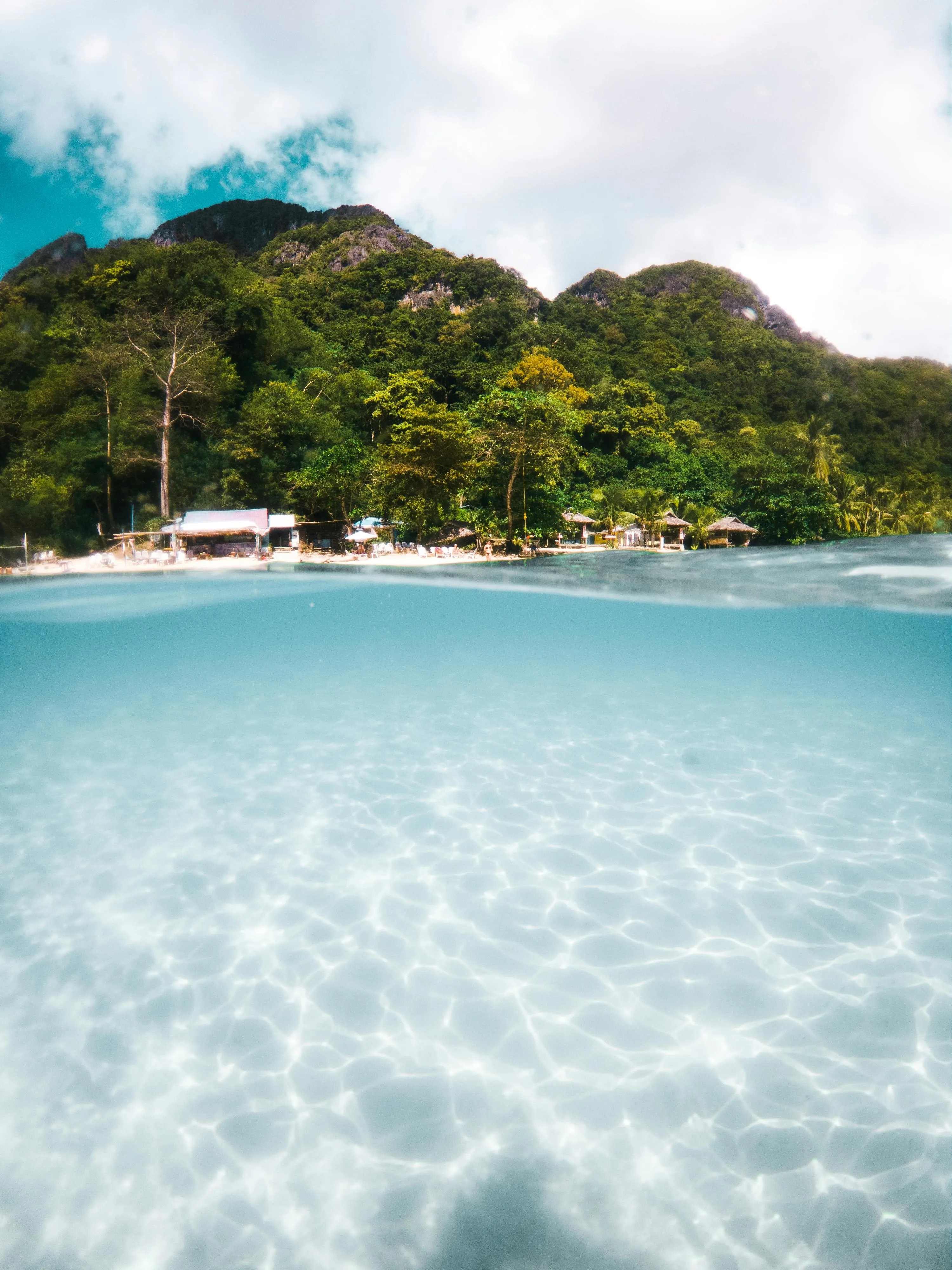 Crystal Clear Water Reflecting an Island and the Sky