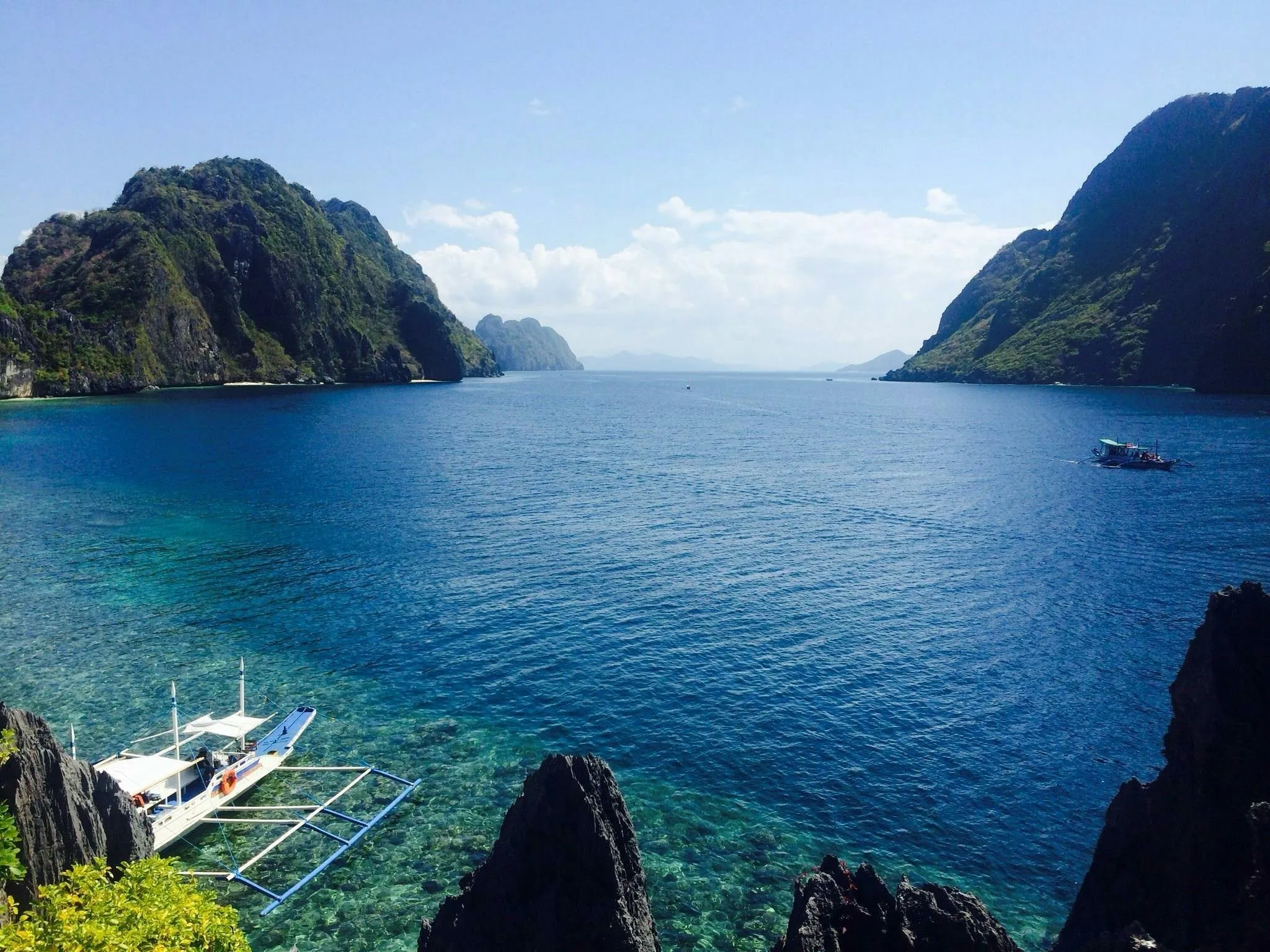 Crystal Clear Waters in the Green Cliffs and the Boats