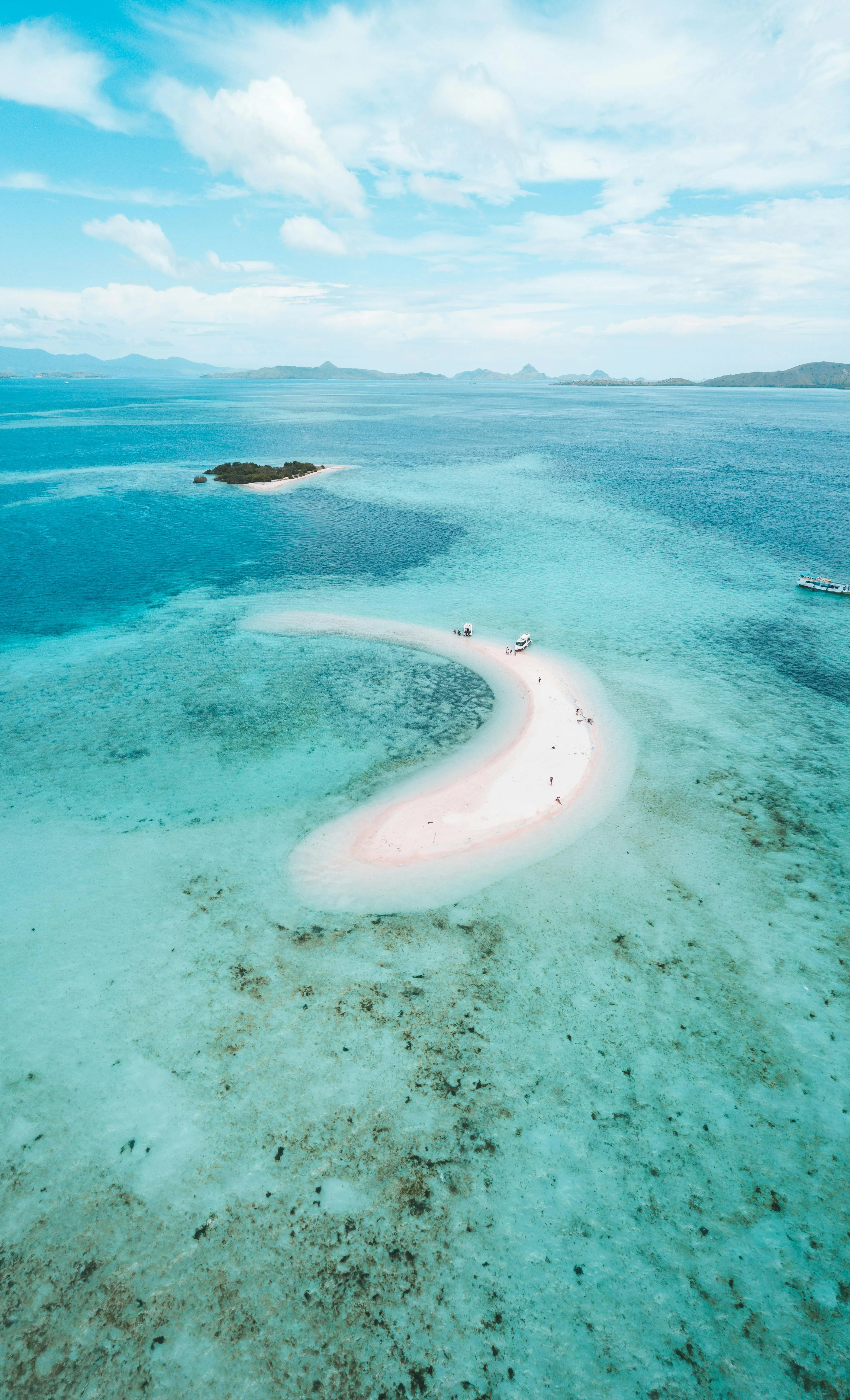 Curved White Sandbar Stretching into Clear Turquoise Water