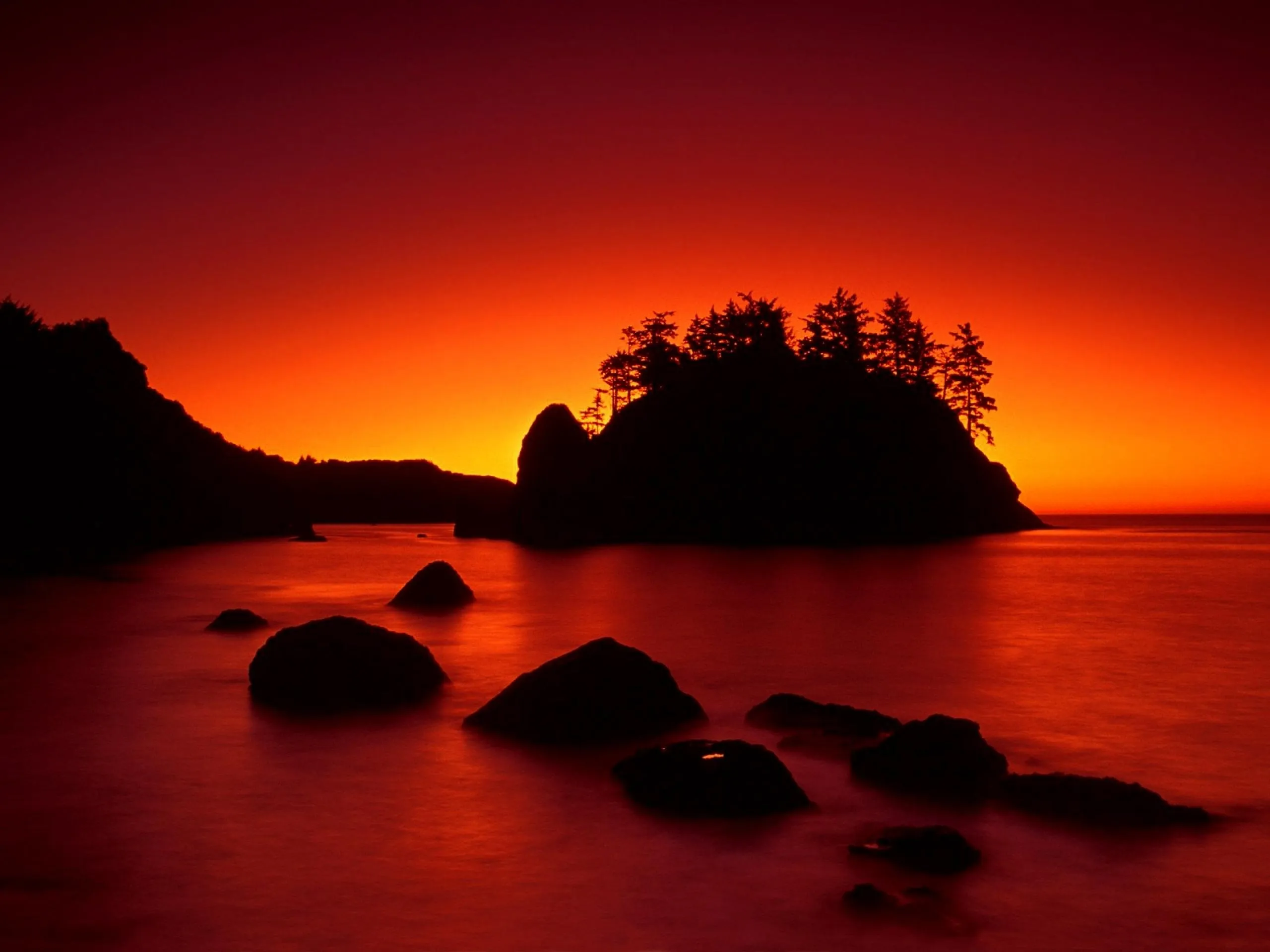 Deep Orange Glowing Sky over a Rocky Island at Evening Time