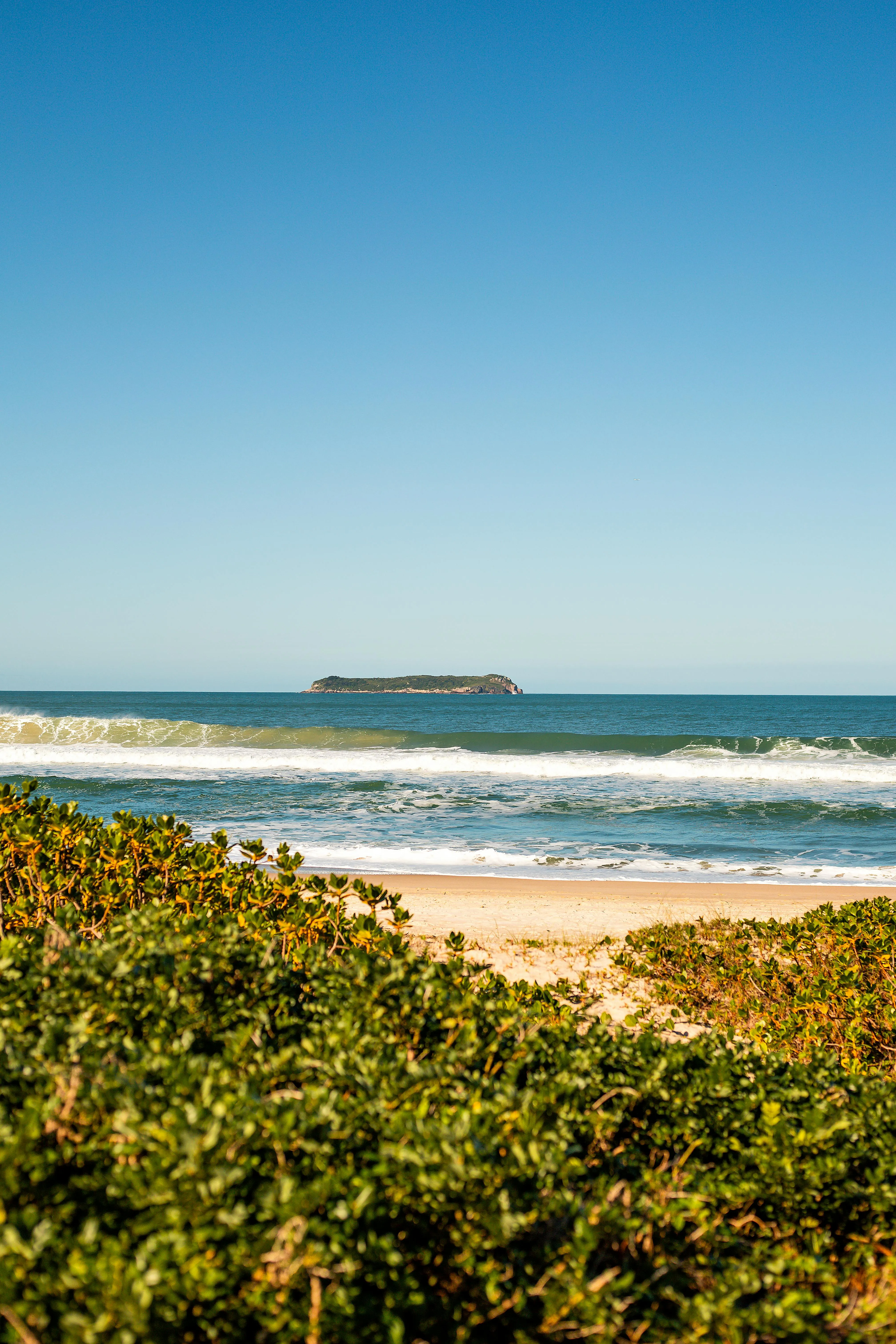 Distant Island and Sandy Beach Peaceful Coastal Landscape