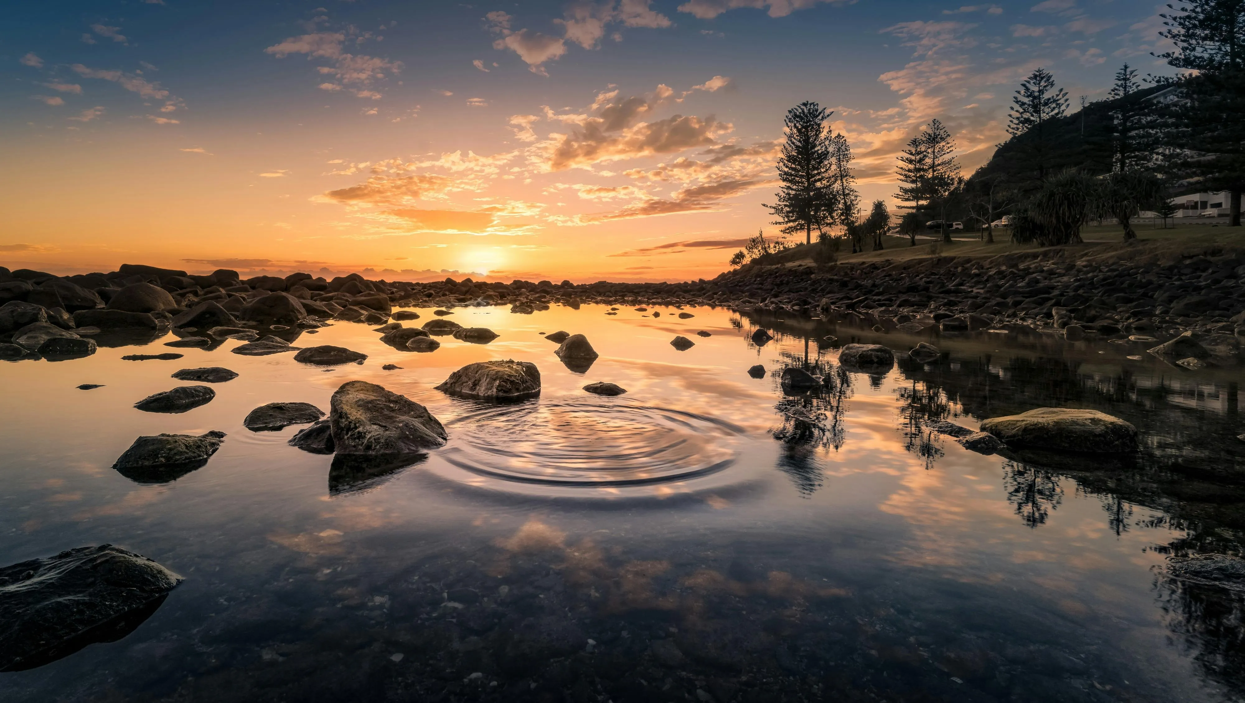 Download Serene Rocky Shore Sunset Wallpaper in Ultra HD