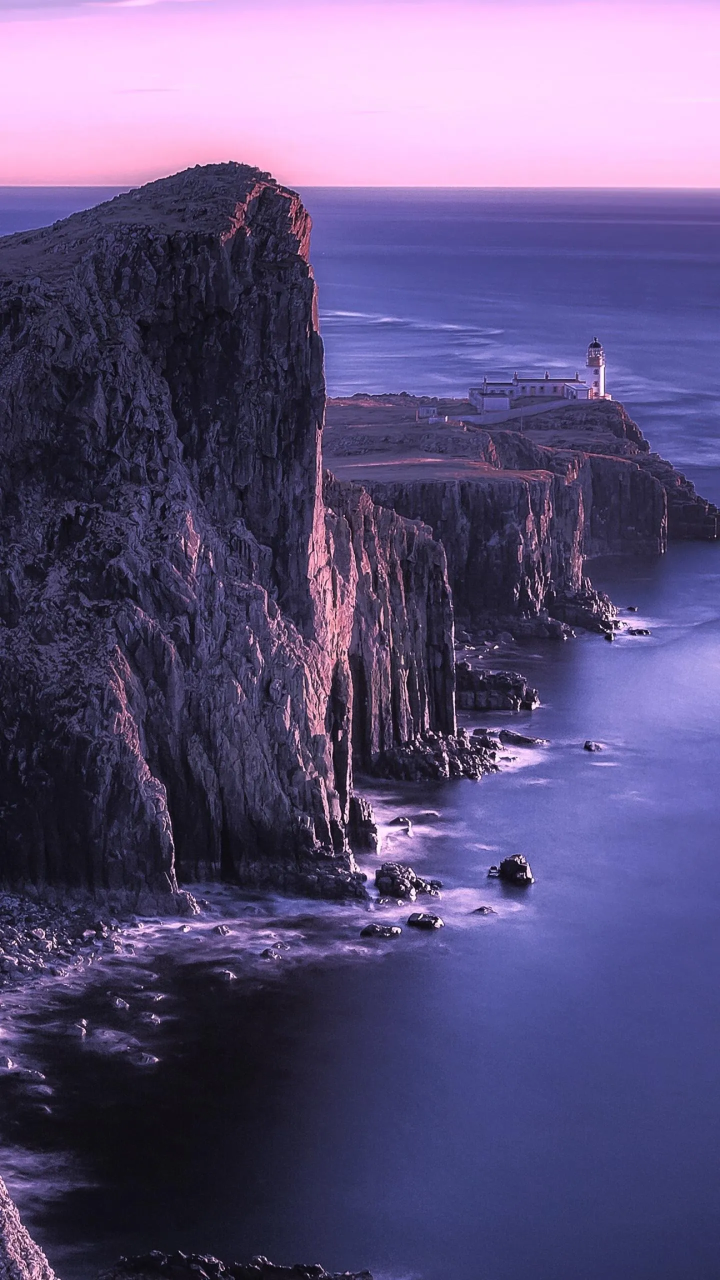 Dramatic Rocky Cliffs with a Lighthouse Portrait Wallpaper