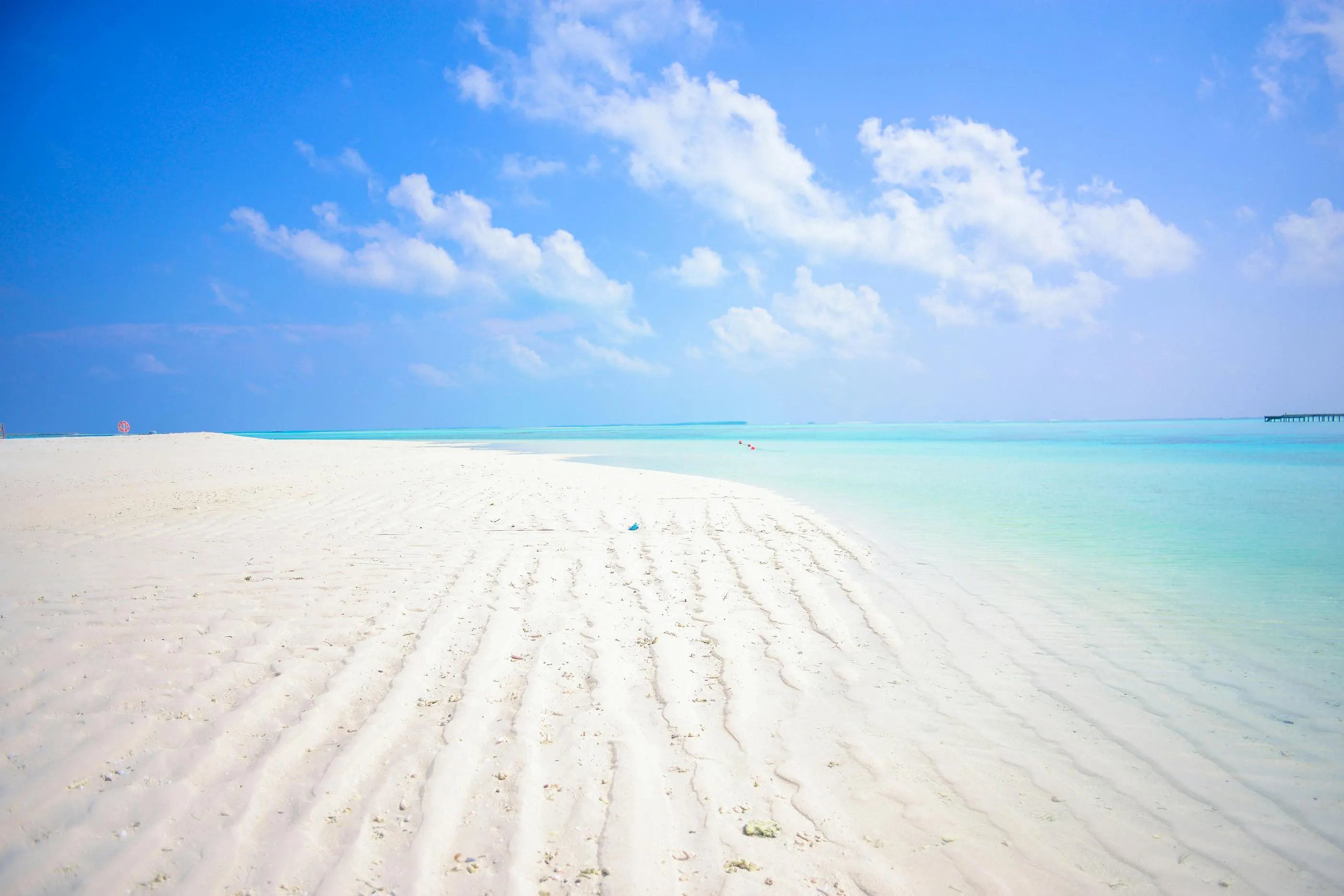 Empty White Sandy Beach Under a Bright Sky and Blue Ocean