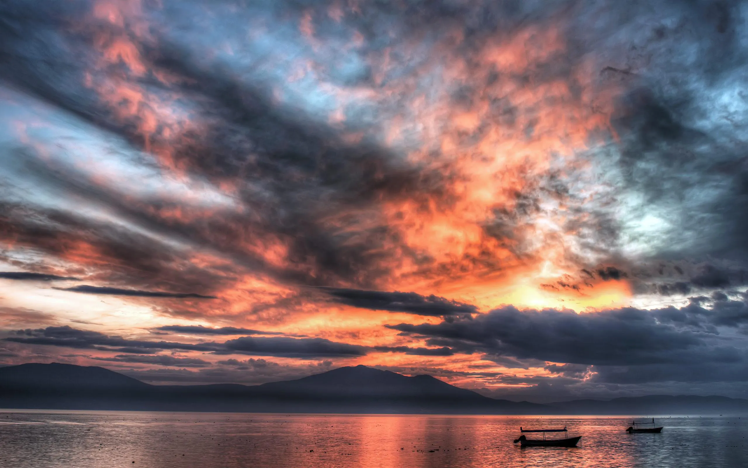 Fiery Red and Blue Sunset over Calm Sea with Reflections