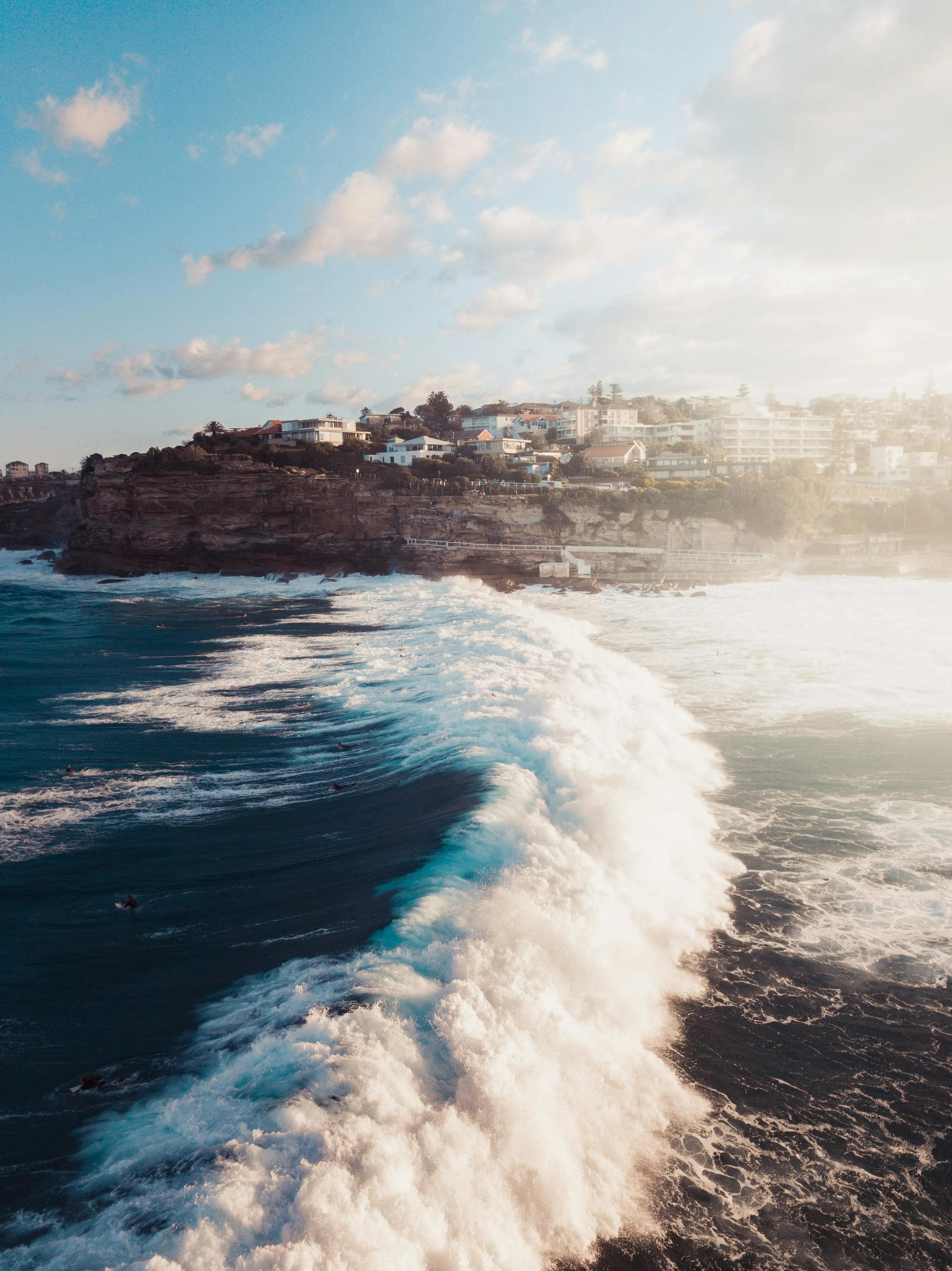 Foamy Sea Waves Crashing Along a Quiet Rock Free Wallpaper