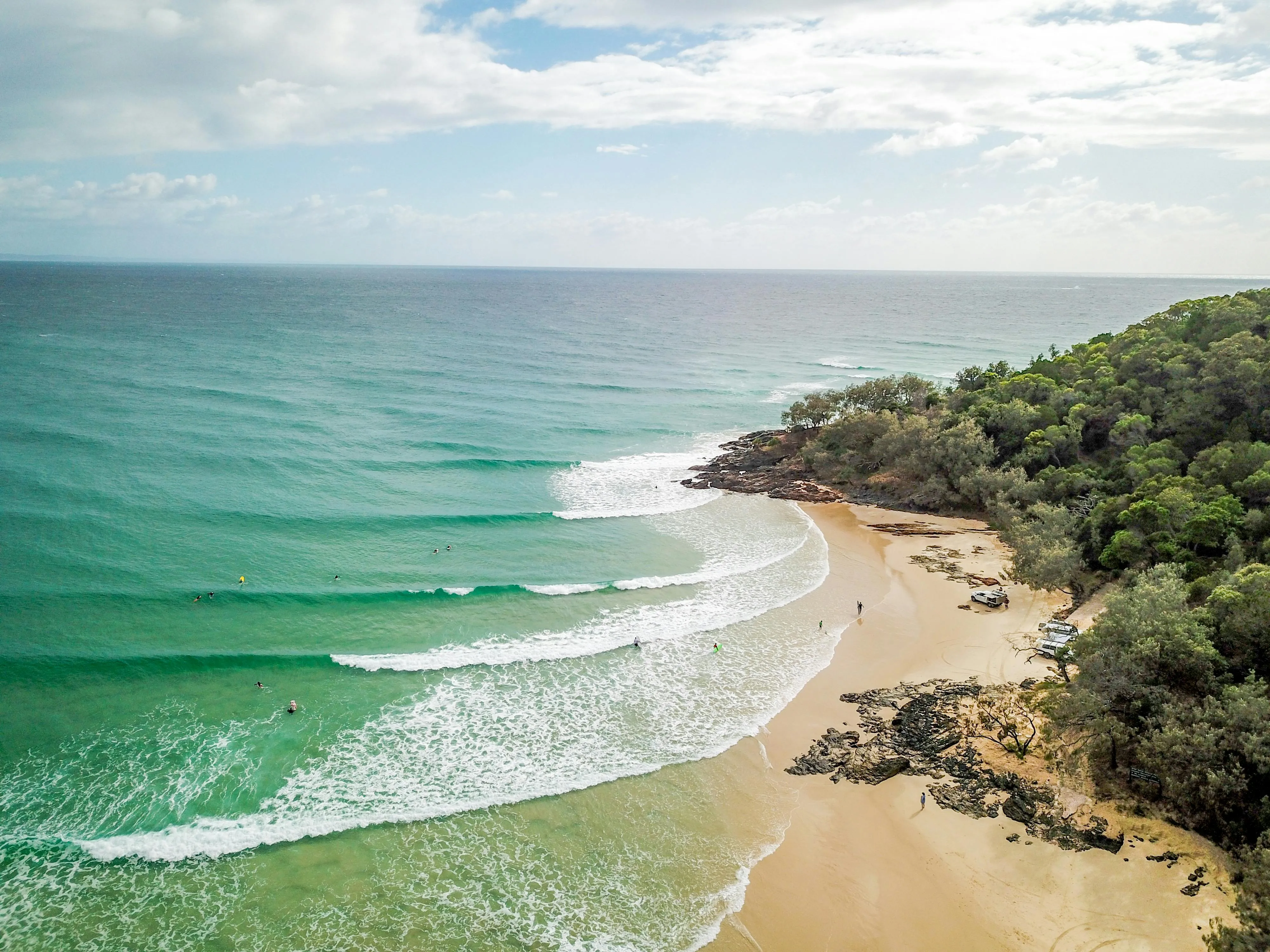 Gentle Waves Crashing Onto an Empty Curved Tropical Beach