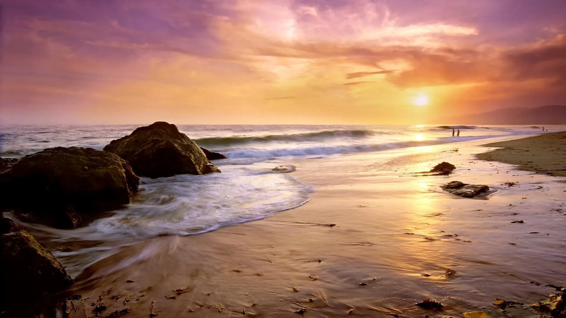 Golden Light Hits Rocks and Waves During Sunset Wallpaper