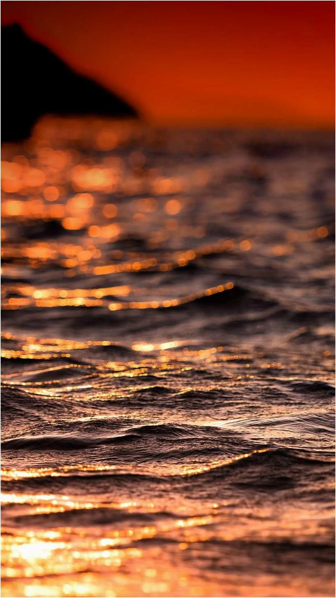 Golden Ocean Waves at Sunset with Fiery Reflection Wallpaper